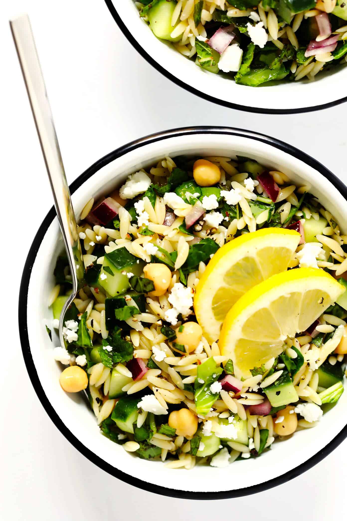 LOVE this Herb-Lovers Lemony Orzo Salad recipe! It's filled with lots of fresh basil, mint, cucumber, red onion, chickpeas, and feta. It's naturally vegetarian and vegan (if you nix the cheese). It's perfect for summer dinners and potlucks, and always a crowd fave! | Gimme Some Oven #pastasalad #orzo #potluck #vegetarian #vegan Herb-Lovers Lemony Orzo Pasta Salad Recipe | 20 Vegetarian Dinner Ideas