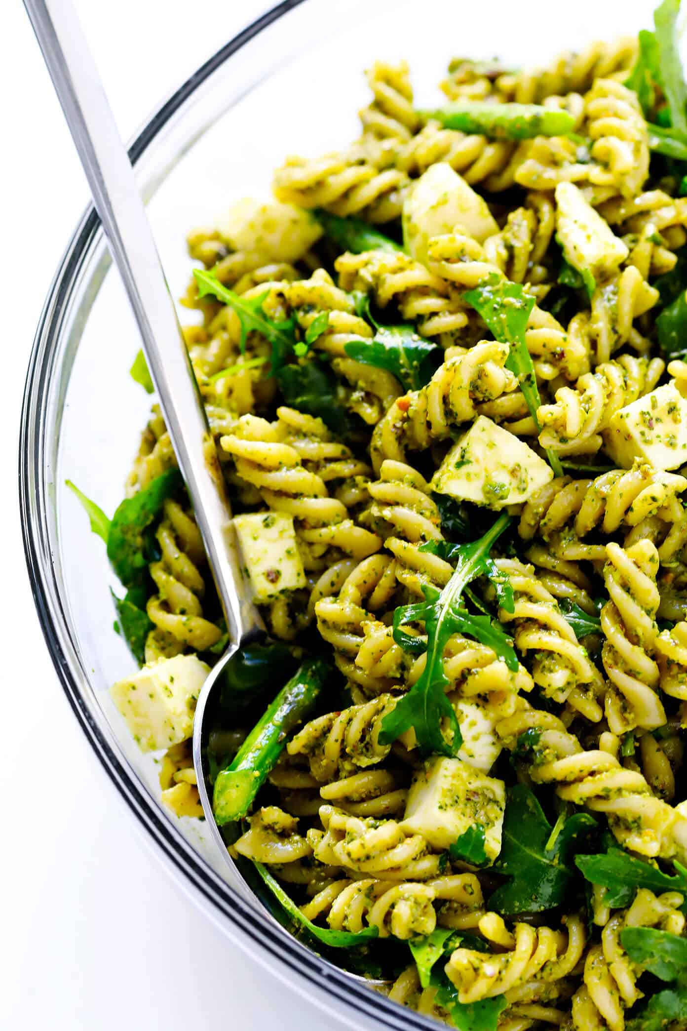 This Pistachio Pesto Pasta Salad recipe is made with asparagus (or your choice of veggie), arugula, mozzarella, and the most delicious pistachio basil pesto. The perfect make-ahead recipe for summer dinner! | Gimme Some Oven #pastasalad #pesto #summer #dinner #recipe #potluck Pistachio Pesto Pasta Salad Recipe