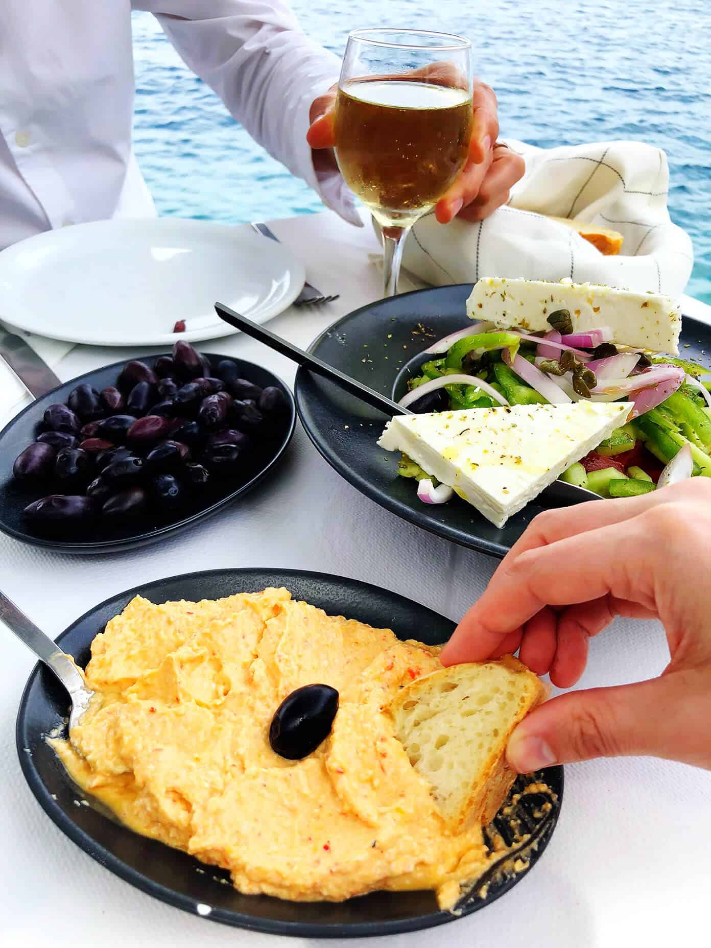 LOVE this Spicy Greek Feta Dip (Tirokafteri)! It's made with creamy feta cheese, roasted red peppers and garlic, and it's the perfect appetizer or snack. Serve it with bread, veggies, or whatever sounds good. | Gimme Some Oven #cheese #dip #appetizer #greek #spicy Ammoudi Sunset Tavern in Santorini