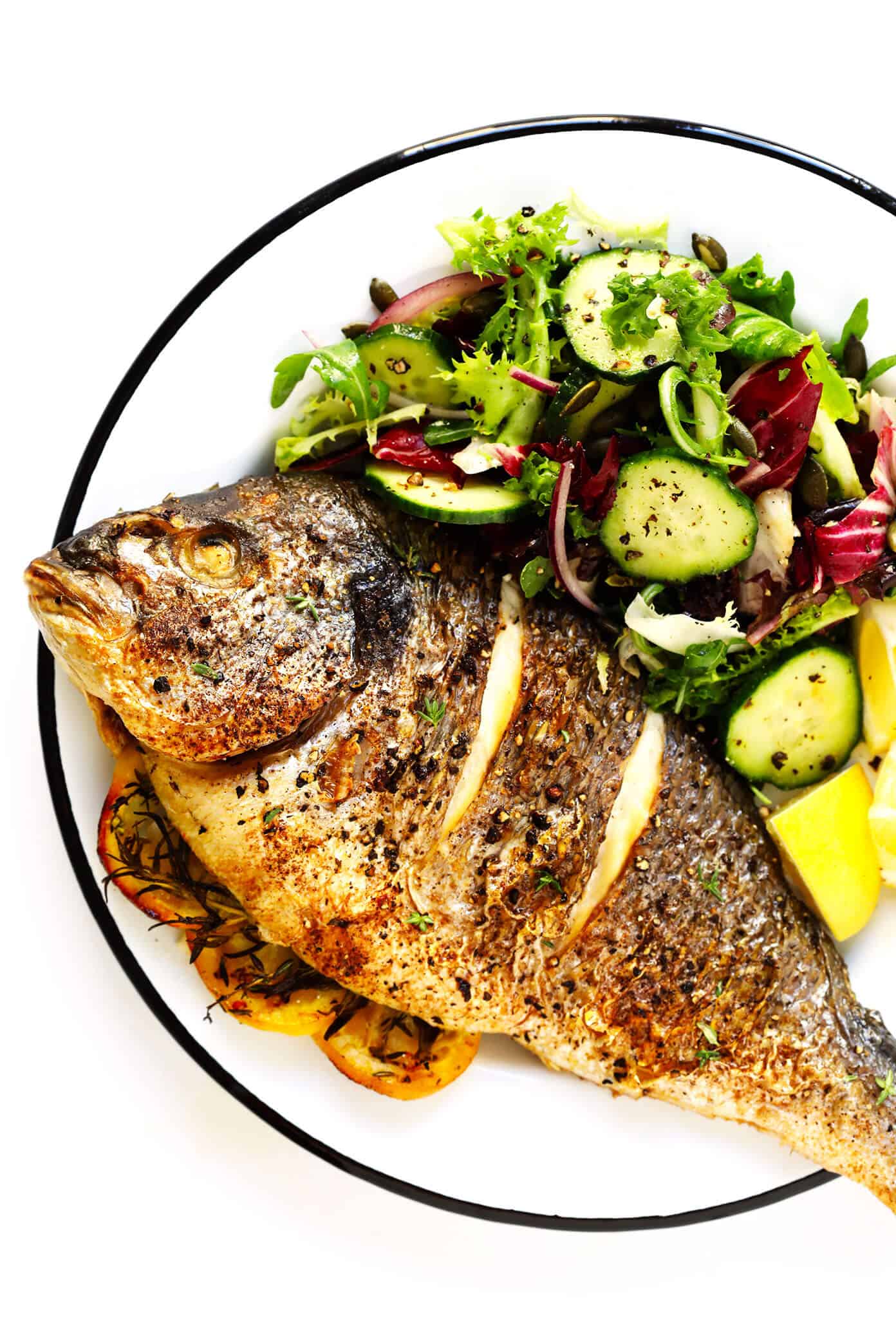 Learn how to cook a whole fish in the oven with this easy step-by-step tutorial and recipe! It's easy to make with mahi mahi, sea bass, branzino, red snapper, or whatever your favorite fish may be, and seasoned with a simple blend of lemon, garlic and herbs. The perfect healthy dinner! | Gimme Some Oven #fish #dinner #healthy #recipe #mahimahi #seabass How To Roast Whole Fish In The Oven