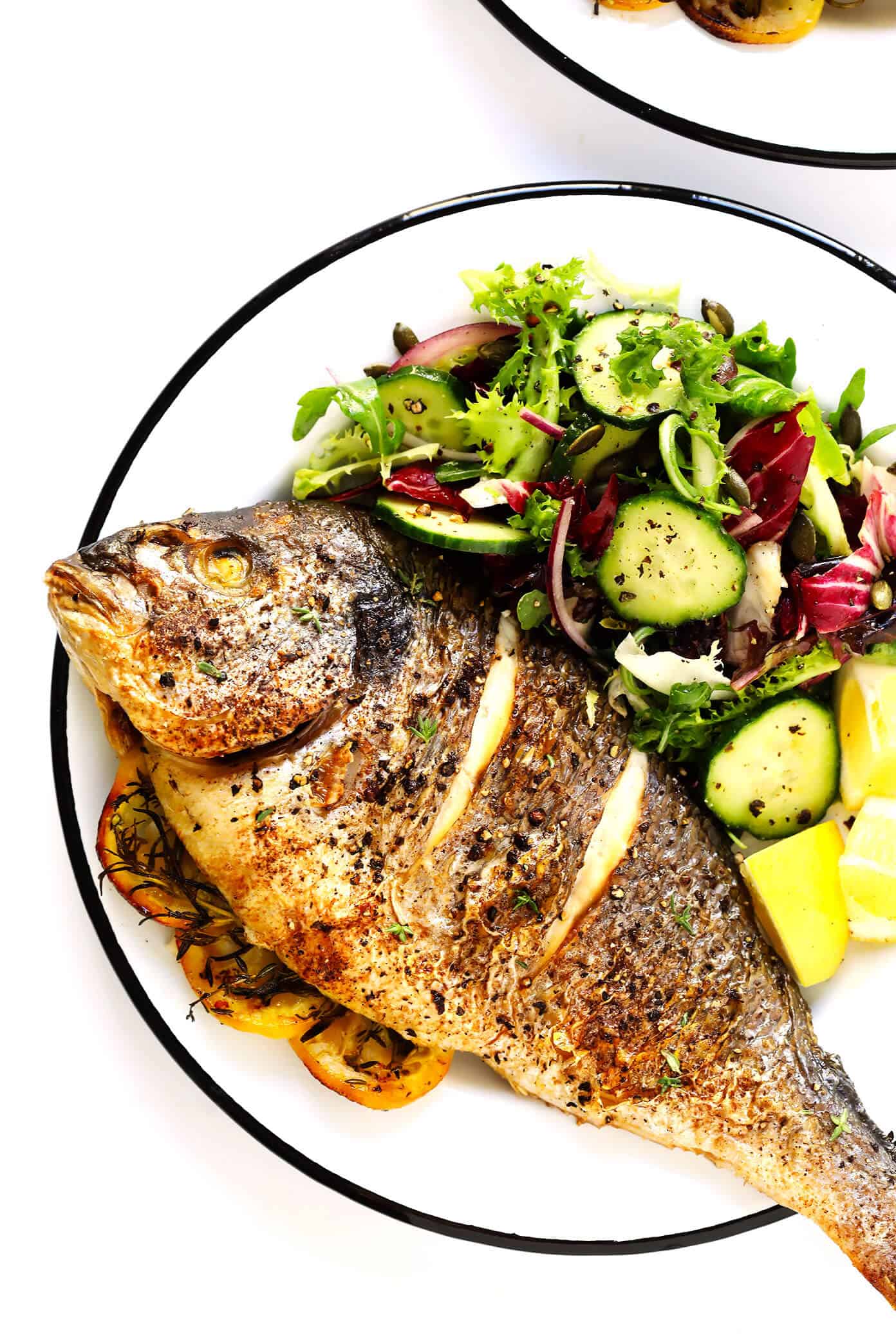 Learn how to cook a whole fish in the oven with this easy step-by-step tutorial and recipe! It's easy to make with mahi mahi, sea bass, branzino, red snapper, or whatever your favorite fish may be, and seasoned with a simple blend of lemon, garlic and herbs. The perfect healthy dinner! | Gimme Some Oven #fish #dinner #healthy #recipe #mahimahi #seabass How To Make Whole Fish In The Oven -- a step by step tutorial