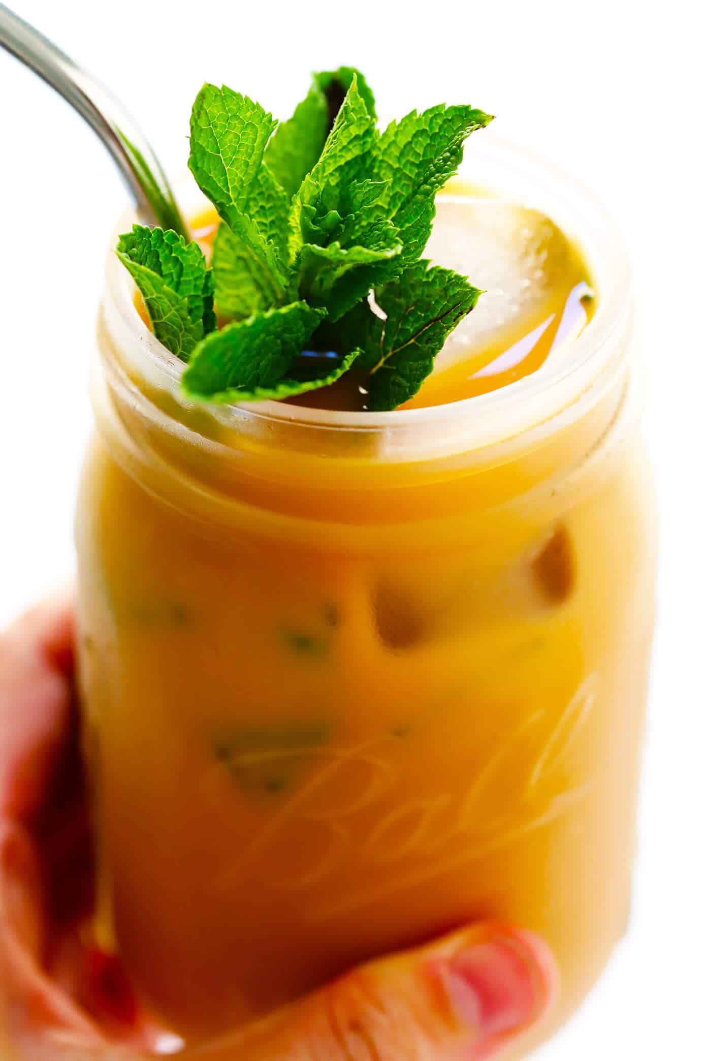 This Mint Mojito Iced Coffee is a TOTAL game-changer. It's easy to make with regular brewed filter coffee, lots of fresh milk, a hint of cream (or coconut milk), your choice of sweetener...and it tastes unbelievably refreshing and delicious! It's the perfect summer drink! | Gimme Some Oven #coffee #icedcoffee #drink #mint Mint Mojito Iced Coffee Recipe