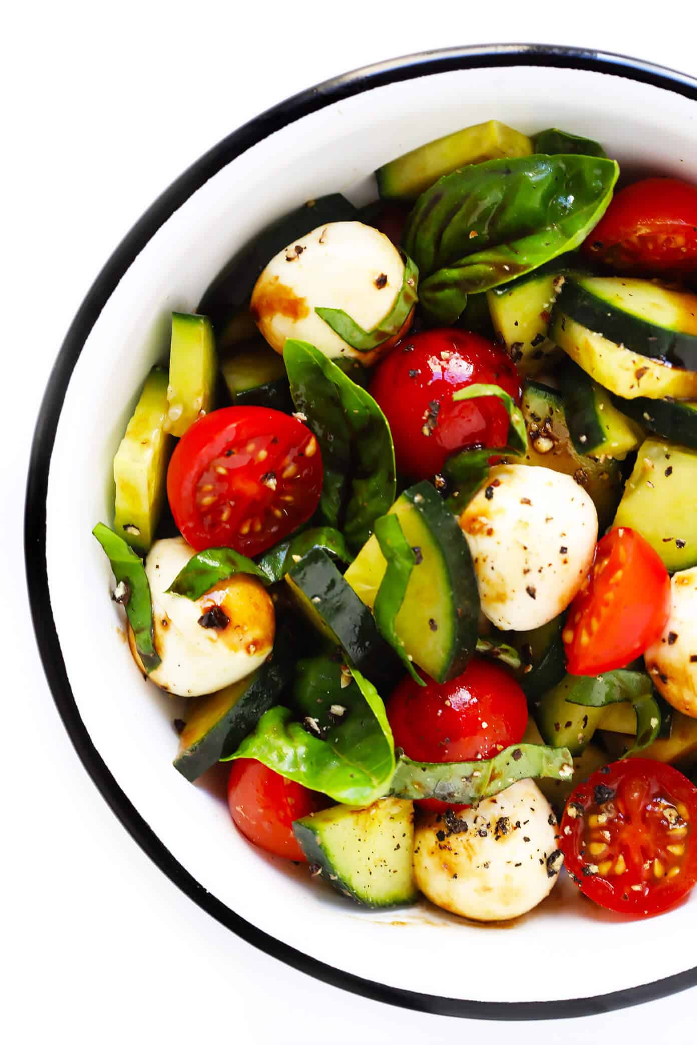 This Caprese Cucumber Salad recipe is quick and easy to make with 5 main ingredients -- fresh cucumber, tomato, basil, mozzarella and an easy balsamic glaze. Feel free to stir in some pasta if you'd like, too, to make a pasta salad! | Gimme Some Oven #caprese #cucumber #salad #pastasalad #summer #dinner #recipe Quick Cucumber Caprese Salad