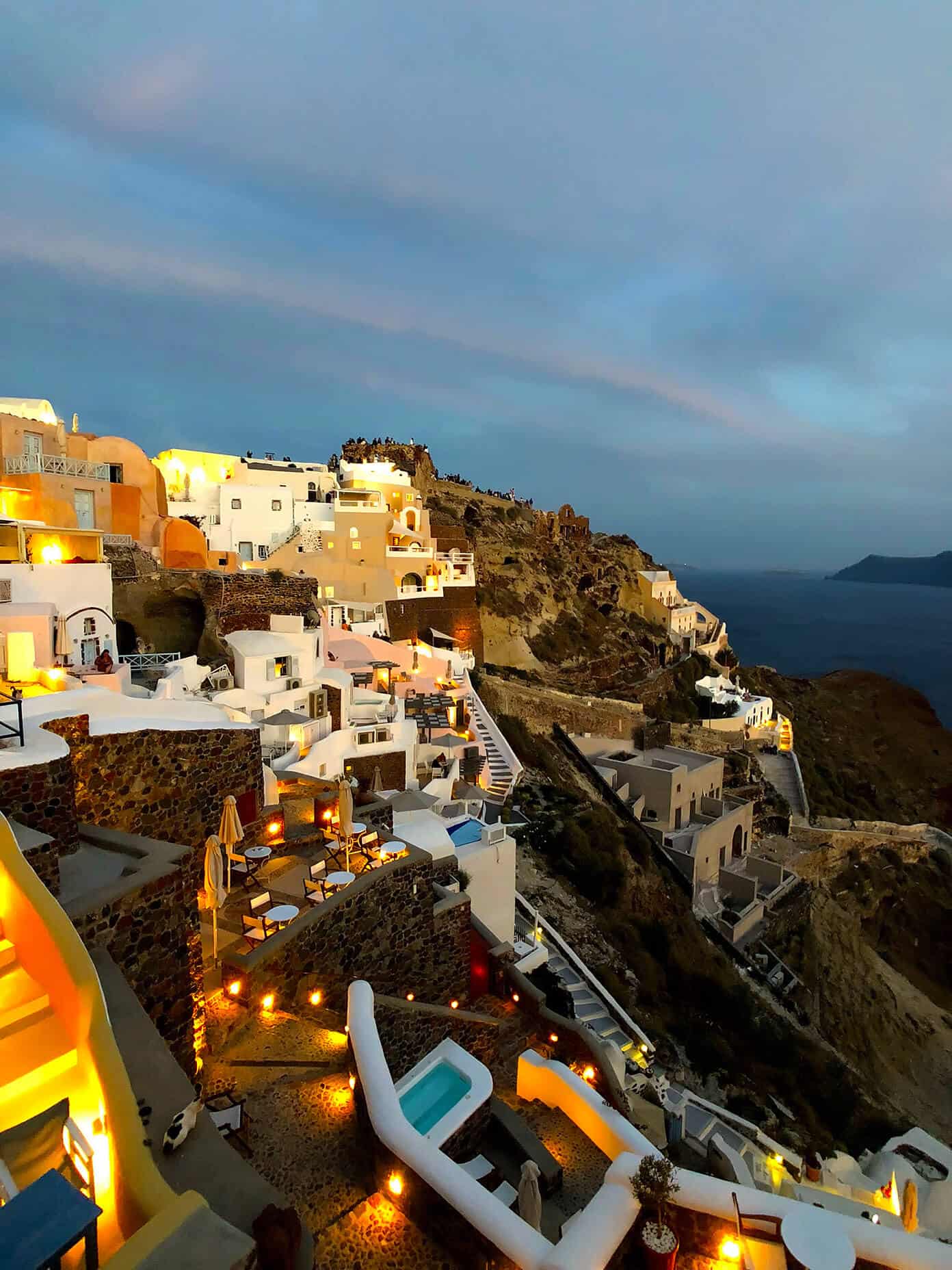 The Gimme Some Oven travel guide for restaurants to eat, hotels to stay and places to visit in Santorini, Greece. | Gimme Some Oven #santorini #greece #travel #traveltips #europe #vacation #islands #hotel #restaurant Sunset in Oia Santorini Greece