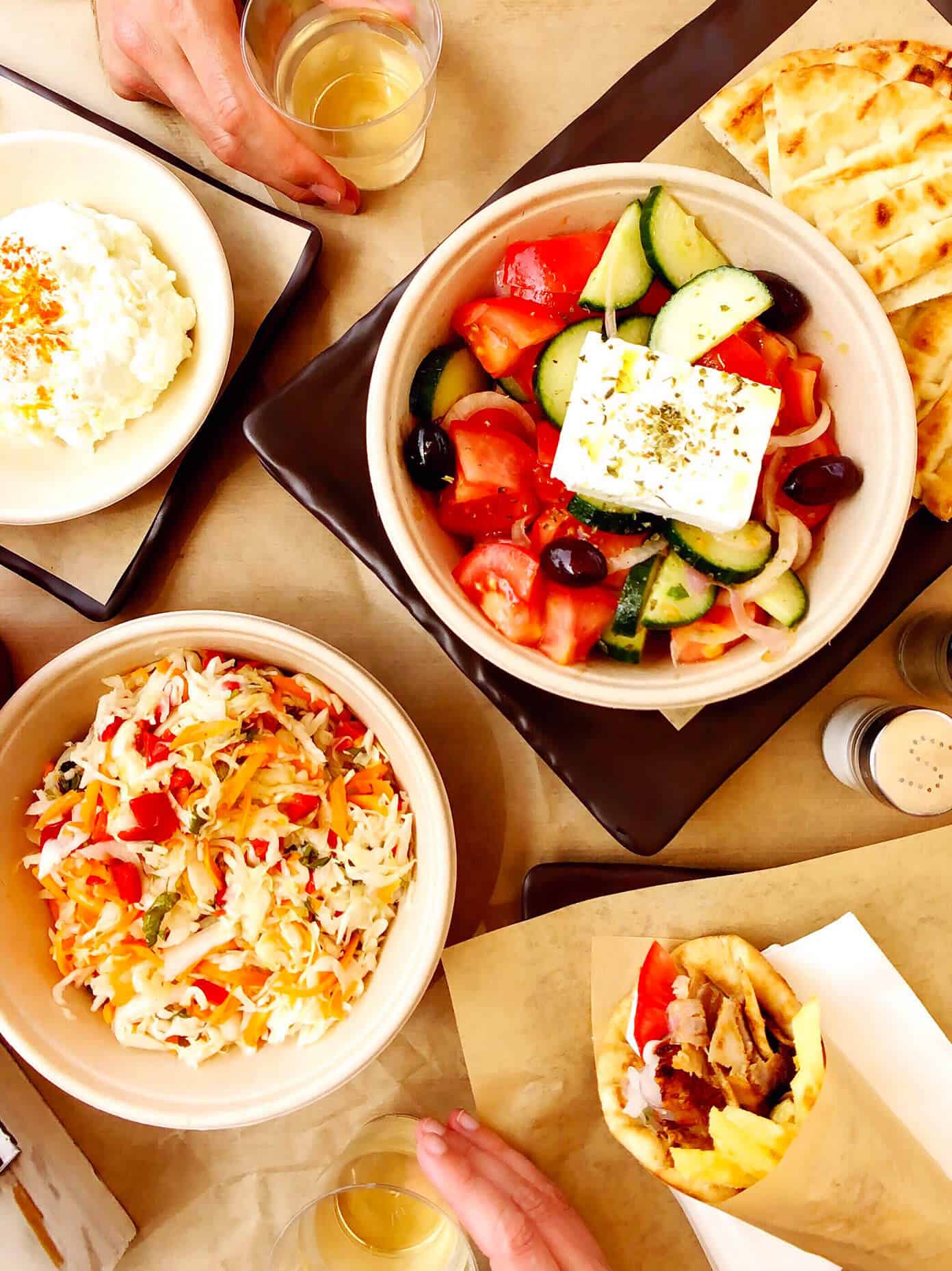 The Gimme Some Oven travel guide for restaurants to eat, hotels to stay and places to visit in Santorini, Greece. | Gimme Some Oven #santorini #greece #travel #traveltips #europe #vacation #islands #hotel #restaurant Lunch (Greek Salad, Gyros, Spicy Cheese Dip, Wine) at PitoGyros in Santorini, Greece