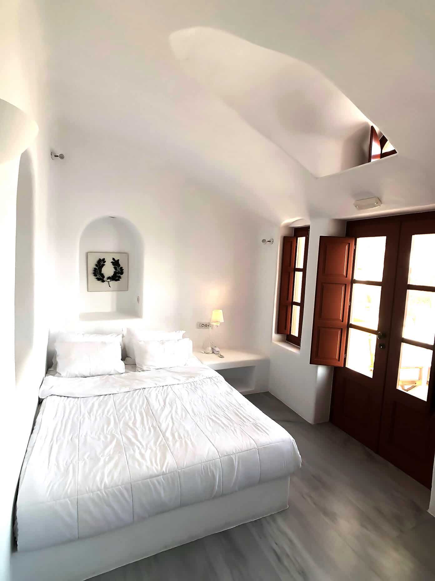 The Gimme Some Oven travel guide for restaurants to eat, hotels to stay and places to visit in Santorini, Greece. | Gimme Some Oven #santorini #greece #travel #traveltips #europe #vacation #islands #hotel #restaurant Hotel Room at Oia Mare Villas in Santorini Greece
