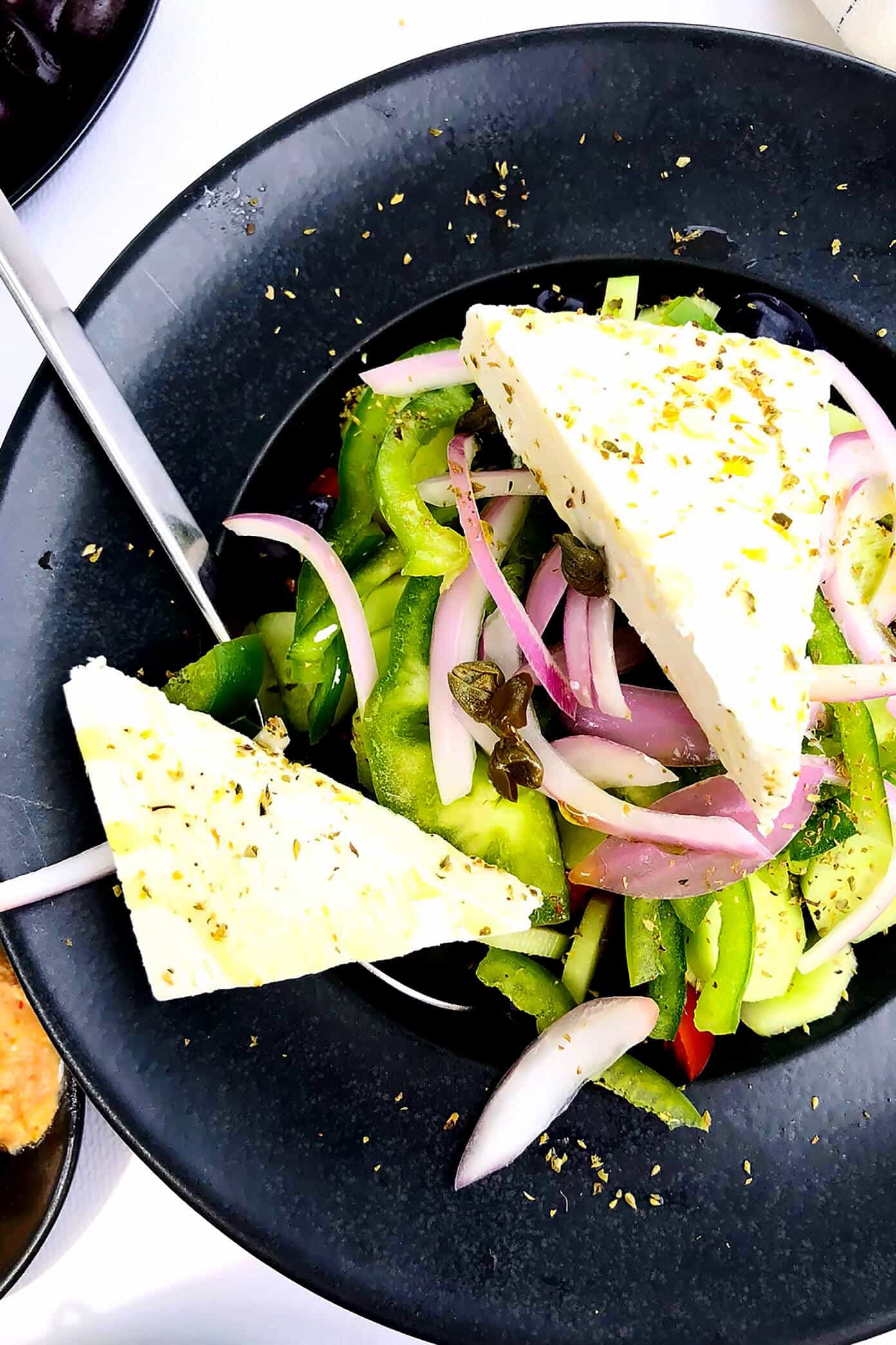 The Gimme Some Oven travel guide for restaurants to eat, hotels to stay and places to visit in Santorini, Greece. | Gimme Some Oven #santorini #greece #travel #traveltips #europe #vacation #islands #hotel #restaurant Greek Salad at Sunset Tavern in Santorini, Greece