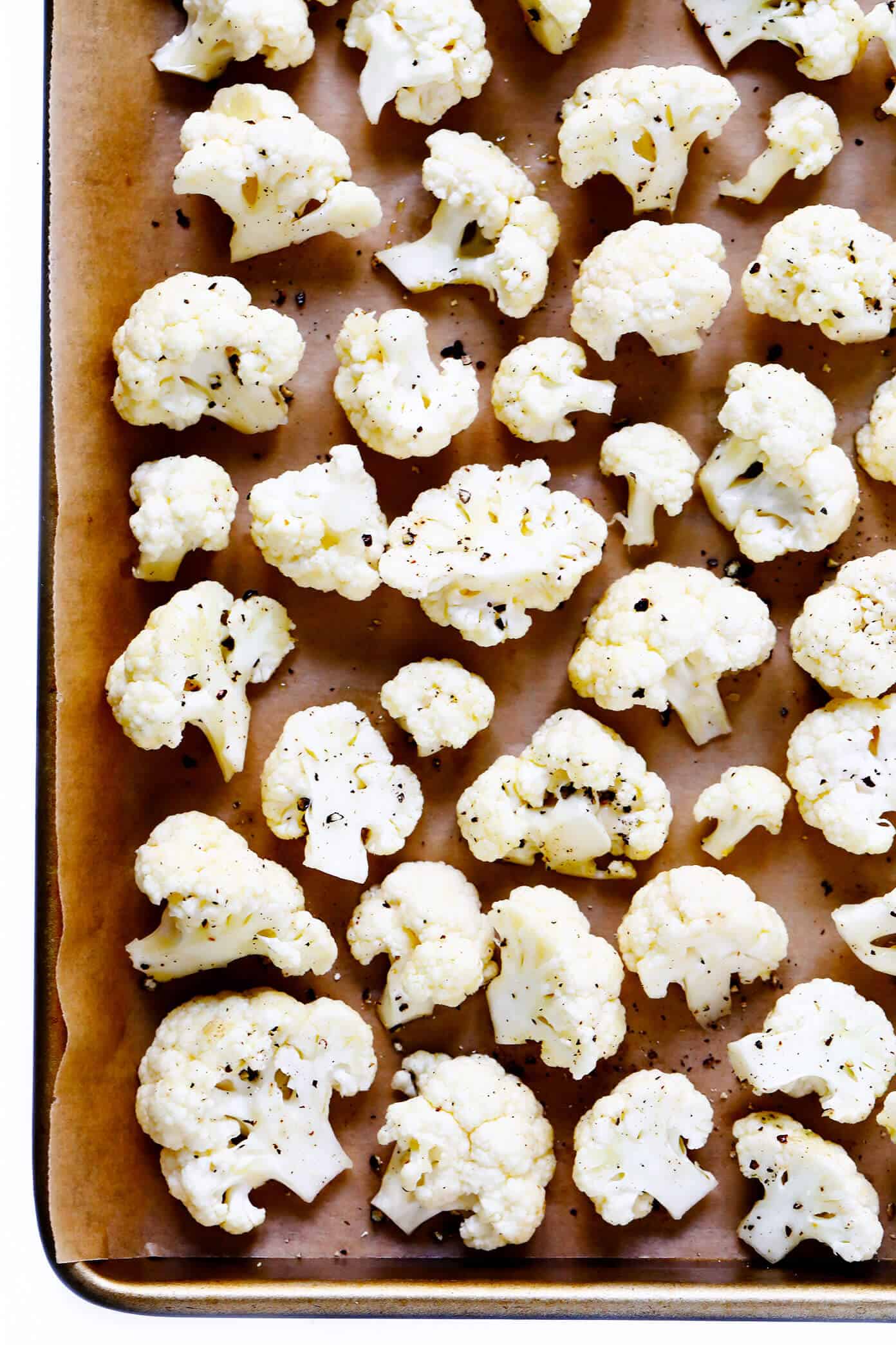 The BEST Roasted Cauliflower recipe -- super easy to make in the oven, naturally #glutenfree and #vegan, and easy to customize with any of your favorite seasonings. It's the perfect healthy side dish. Or perfect for adding to a salad, soup, pizza, dip, pasta, tacos or more! | Gimme Some Oven Raw Cauliflower | Roasted Cauliflower Recipe