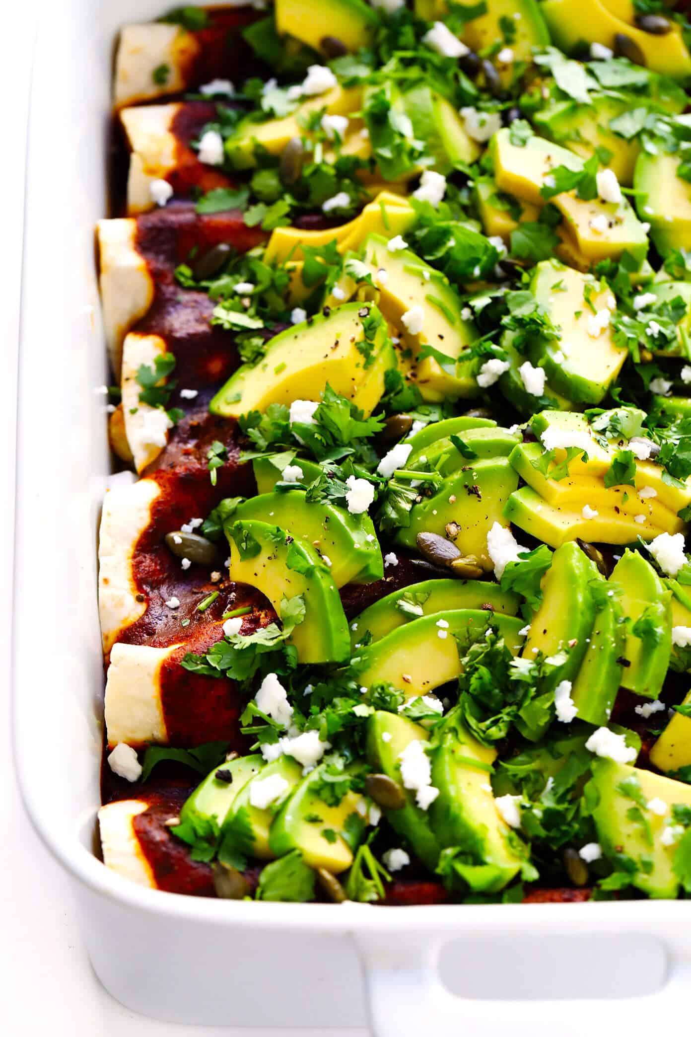 LOVE Roasted Cauliflower Enchiladas recipe! This vegetarian enchiladas recipe is full of caramelized roasted cauliflower, beans, cheese, and made with the best homemade enchilada sauce. Then it's loaded up with avocado, cilantro and all of your favorite toppings. It's the perfect Mexican dinner, and also makes great leftovers for meal prep! | Gimme Some Oven #cauliflower The BEST Vegetarian Enchiladas - Roasted Cauliflower Enchiladas