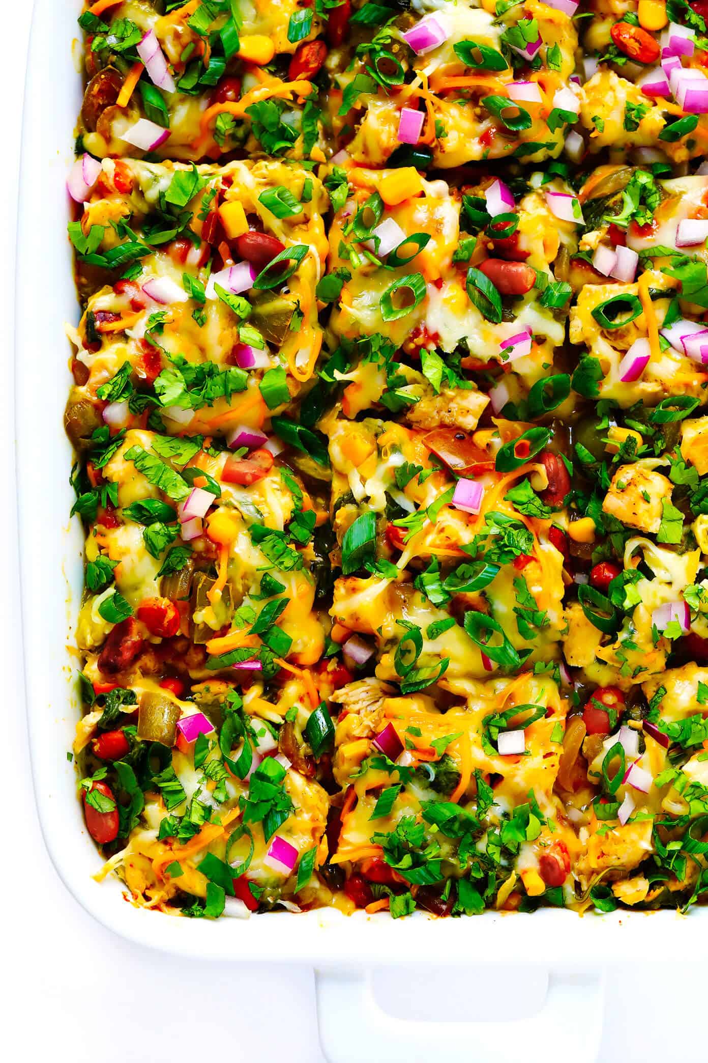 LOVE this Verde Chicken Enchilada Casserole recipe! It's made with your favorite enchilada fillings (chicken, cheese, veggies, beans, corn tortillas). It's tossed with the best homemade green enchilada sauce. It's naturally gluten-free, and easy to customize. And it's absolutely DELICIOUS. The perfect Mexican casserole dinner that's also easy to freeze, and makes great leftovers for meal prep. | Gimme Some Oven #mexican #chicken #casserole #enchilada #glutenfree #dinner #mealprep #cheesy Verde Chicken Enchilada Casserole Recipe