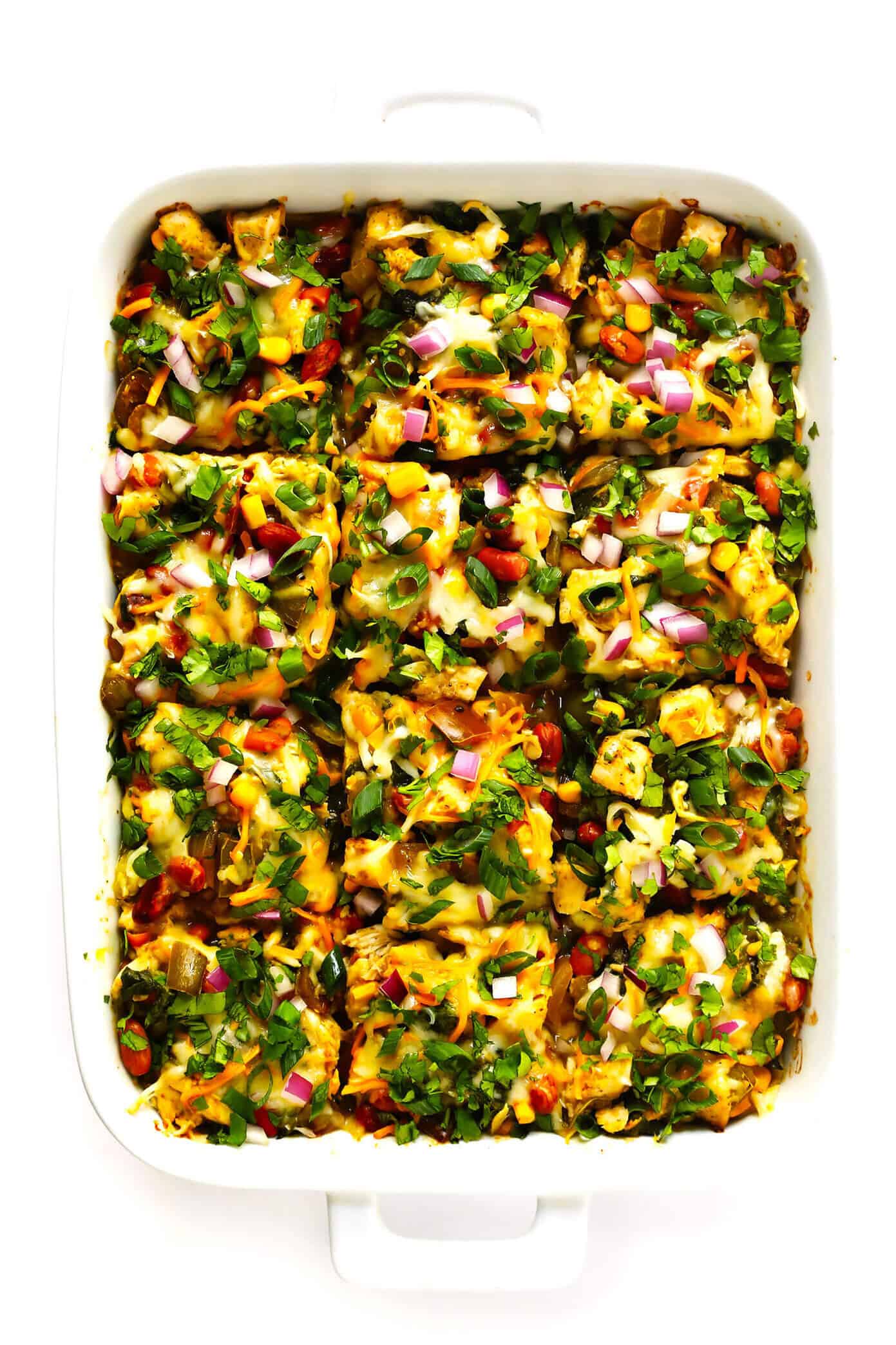 LOVE this Verde Chicken Enchilada Casserole recipe! It's made with your favorite enchilada fillings (chicken, cheese, veggies, beans, corn tortillas). It's tossed with the best homemade green enchilada sauce. It's naturally gluten-free, and easy to customize. And it's absolutely DELICIOUS. The perfect Mexican casserole dinner that's also easy to freeze, and makes great leftovers for meal prep. | Gimme Some Oven #mexican #chicken #casserole #enchilada #glutenfree #dinner #mealprep #cheesy Green Chicken Enchilada Casserole Recipe