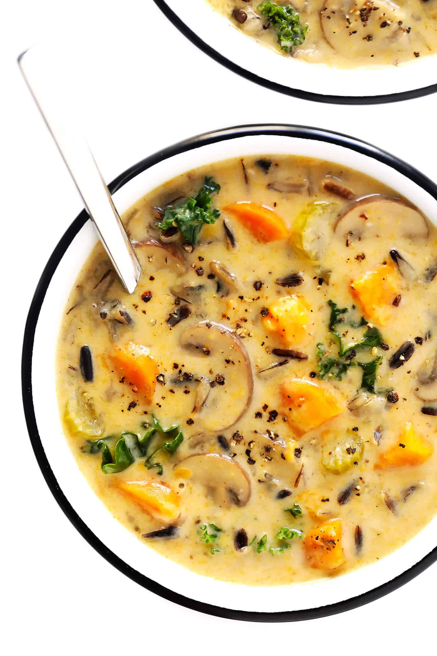 This Cozy Autumn Wild Rice Soup is the perfect fall comfort food! It's easy to make in the Instant Pot (pressure cooker), Crock-Pot (slow cooker), or on the stovetop. It's loaded with sweet potato, kale, mushrooms and other autumn veggies. It's easy to make gluten-free or vegan, if you would like. And it's SO delicious. | Gimme Some Oven #soup #dinner #vegetarian #glutenfree #vegan #comfortfood #thanksgiving Cozy Autumn Wild Rice Soup Recipe