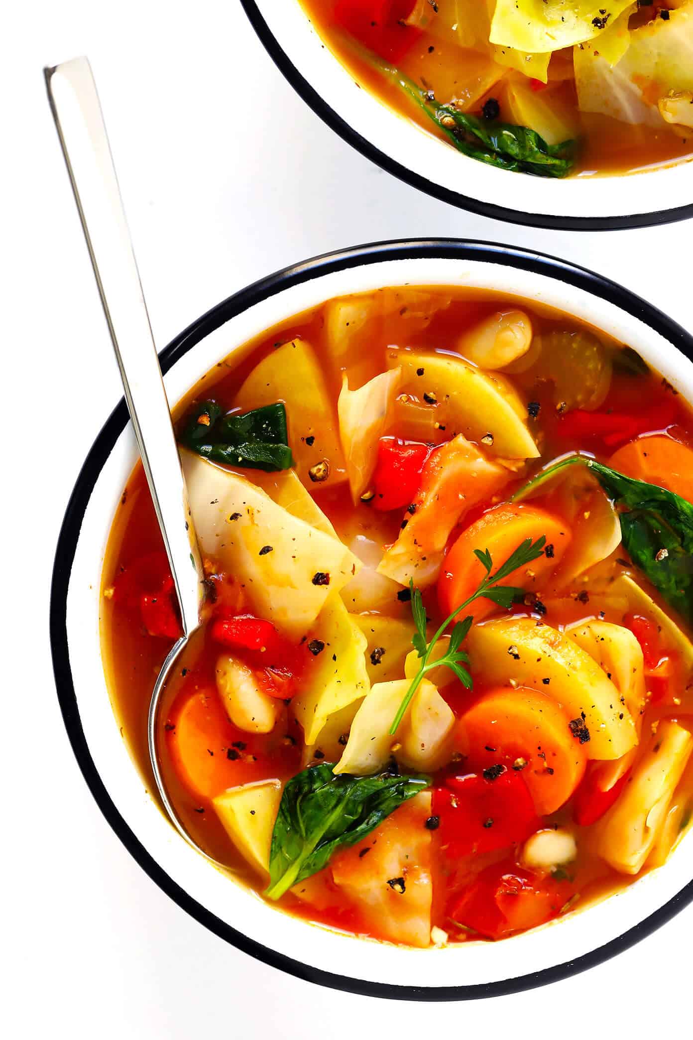 This Spicy Vegetarian Cabbage Soup recipe is made from a mountain of vegetables, simmered in a spicy broth, and tastes like total comfort food. It's also naturally gluten-free and vegan. It's easy to make on the stovetop, or in the Instant Pot (pressure cooker) or Crockpot (slow cooker). It's easy to make ahead for meal prep, or freeze as a freezer meal. And it's SO DELICIOUS. | Gimme Some Oven #cabbage #soup #healthy #dinner #vegan #vegetarian #vegetable #recipe #instantpot #crockpot Healthy Vegetarian Cabbage Soup Recipe