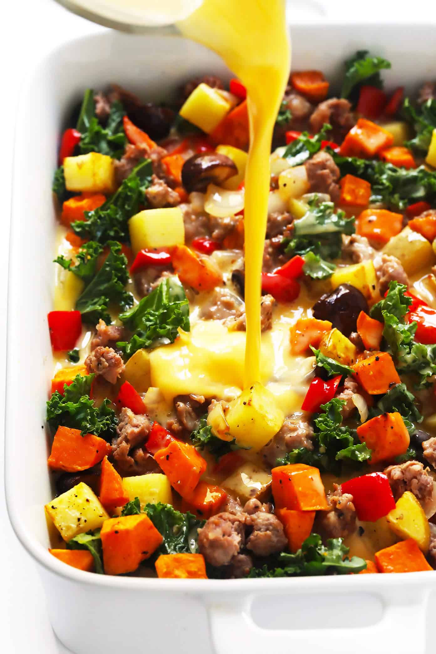 This Cozy Autumn Breakfast Casserole recipe is filled with roasted seasonal veggies (sweet potato, mushrooms, kale and more), sausage (or you can make yours vegetarian), eggs, and a zesty garlic seasoning. Perfect for the holidays, or any fall day that you're craving a delicious brunch. | Gimme Some Oven #breakfast #casserole #glutenfree #holiday #thanksgiving #christmas #fall #autumn #brunch #sausage #egg #glutenfree #makeahead How To Make Breakfast Casserole