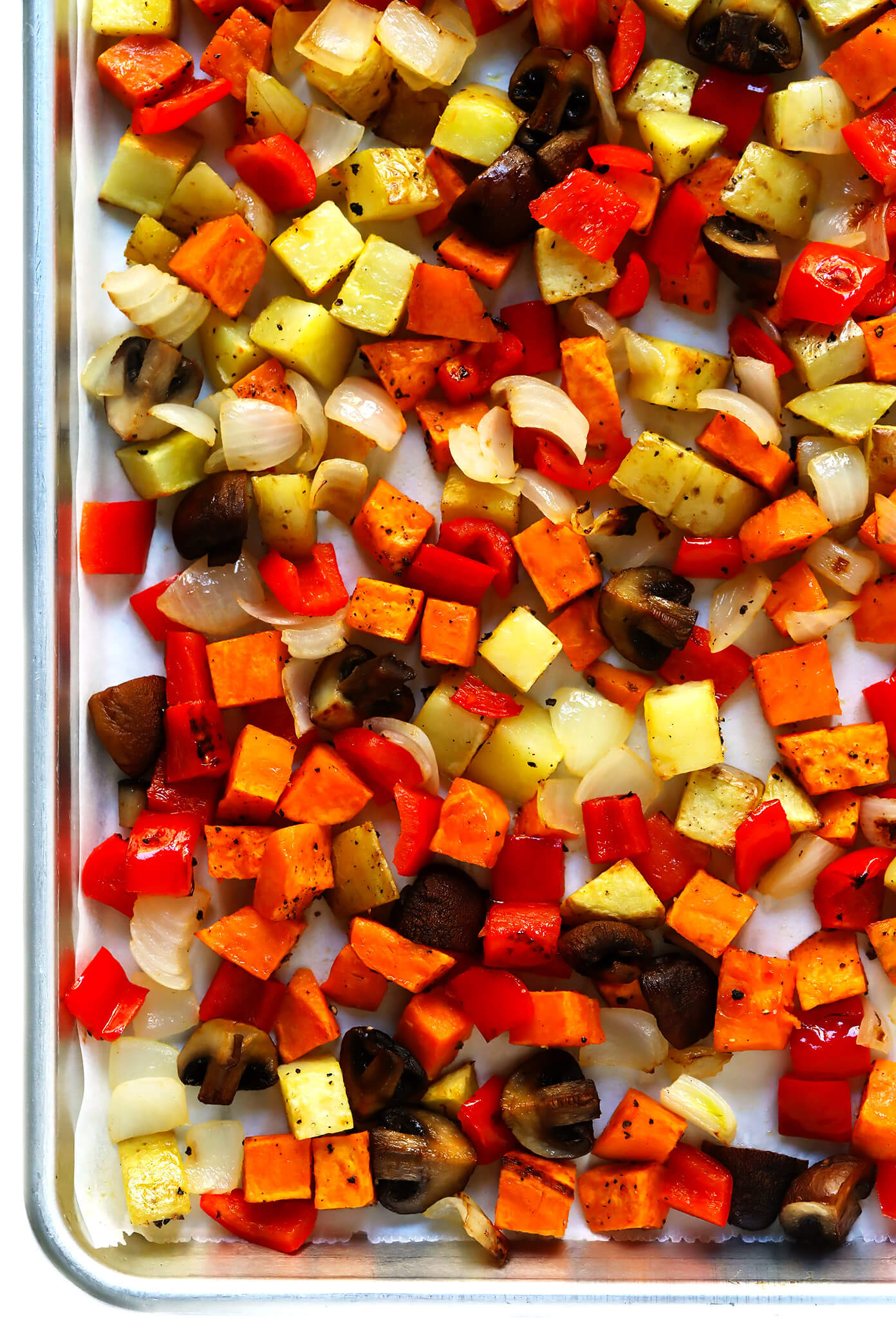 This Cozy Autumn Breakfast Casserole recipe is filled with roasted seasonal veggies (sweet potato, mushrooms, kale and more), sausage (or you can make yours vegetarian), eggs, and a zesty garlic seasoning. Perfect for the holidays, or any fall day that you're craving a delicious brunch. | Gimme Some Oven #breakfast #casserole #glutenfree #holiday #thanksgiving #christmas #fall #autumn #brunch #sausage #egg #glutenfree #makeahead Roasted Vegetables | Cozy Autumn Breakfast Casserole Recipe