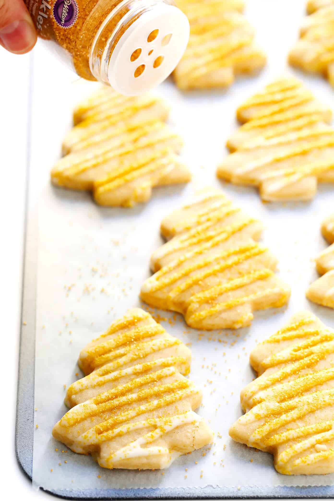 My favorite Brown Sugar Cookie recipe! It's easy to make, holds its shape well with all of your favorite cookie cutters, and always so delicious. Perfect for the holidays or anytime you're craving sugar cookies! | Gimme Some Oven #sugarcookies #cookie #baking #dessert #christmas #holiday #icing Brown Sugar Cookie Christmas Trees with Gold Sprinkles