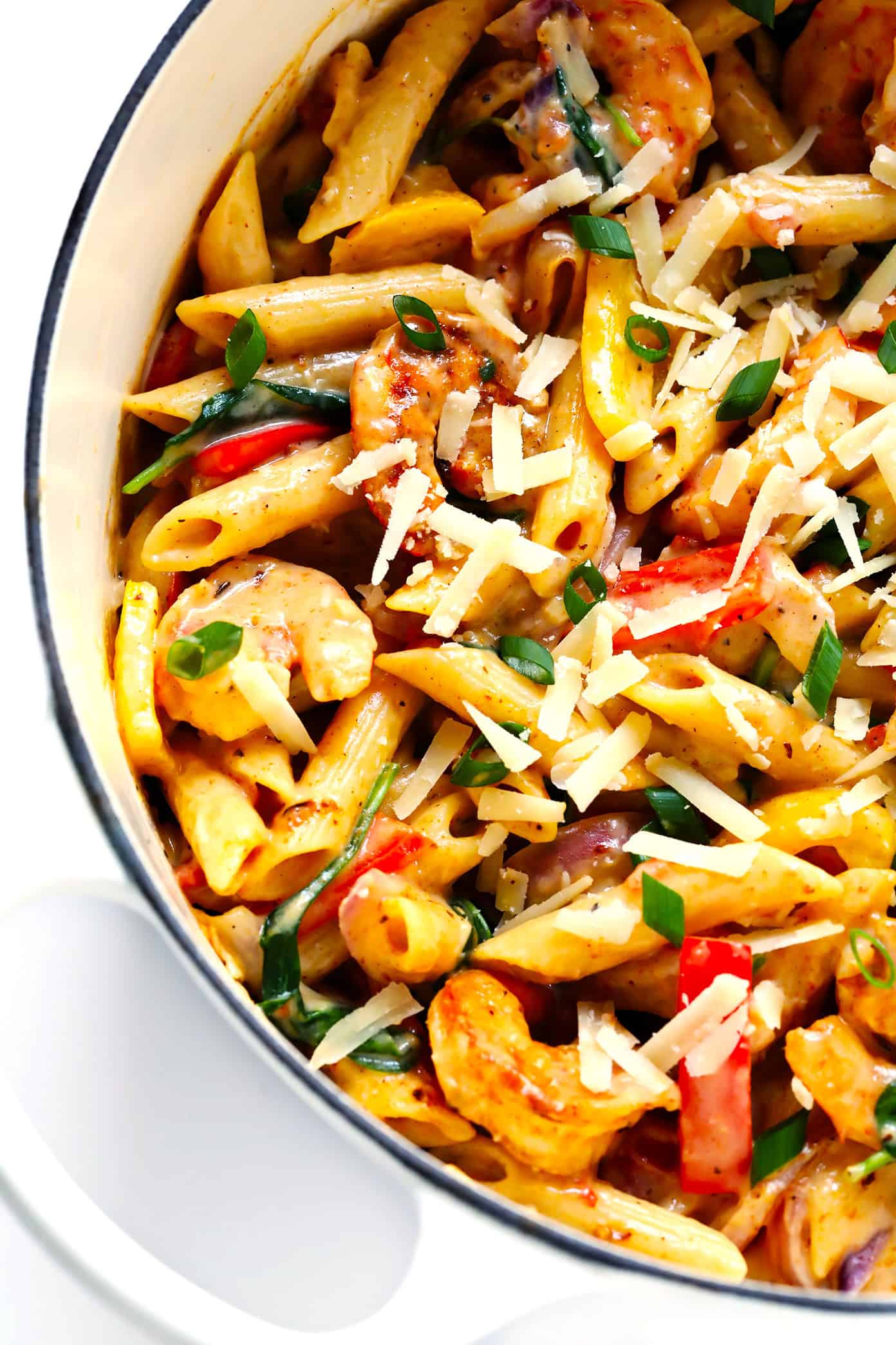 This Cajun Shrimp Pasta recipe is made with the most delicious creamy alfredo sauce, colorful veggies, and zesty shrimp (or chicken, sausage, or your preferred protein). It's comfort food with a kick! | gimmesomeoven.com #pasta #cajun #shrimp #dinner #recipe #alfredo #sauce Creamy Cajun Shrimp Pasta