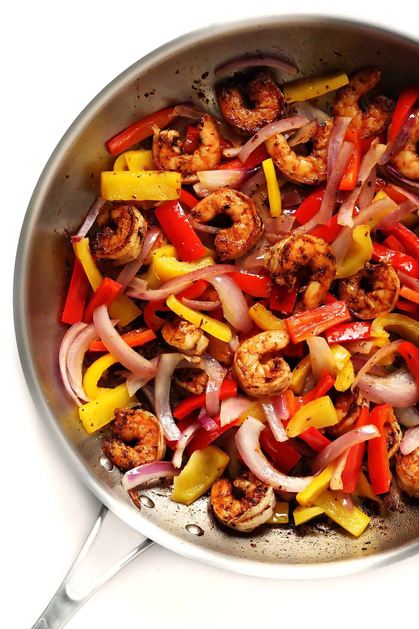 This Cajun Shrimp Pasta recipe is made with the most delicious creamy alfredo sauce, colorful veggies, and zesty shrimp (or chicken, sausage, or your preferred protein). It's comfort food with a kick! | gimmesomeoven.com #pasta #cajun #shrimp #dinner #recipe #alfredo #sauce Cajun Shrimp, Bell Peppers and Red Onion | Cajun Shrimp Pasta Recipe