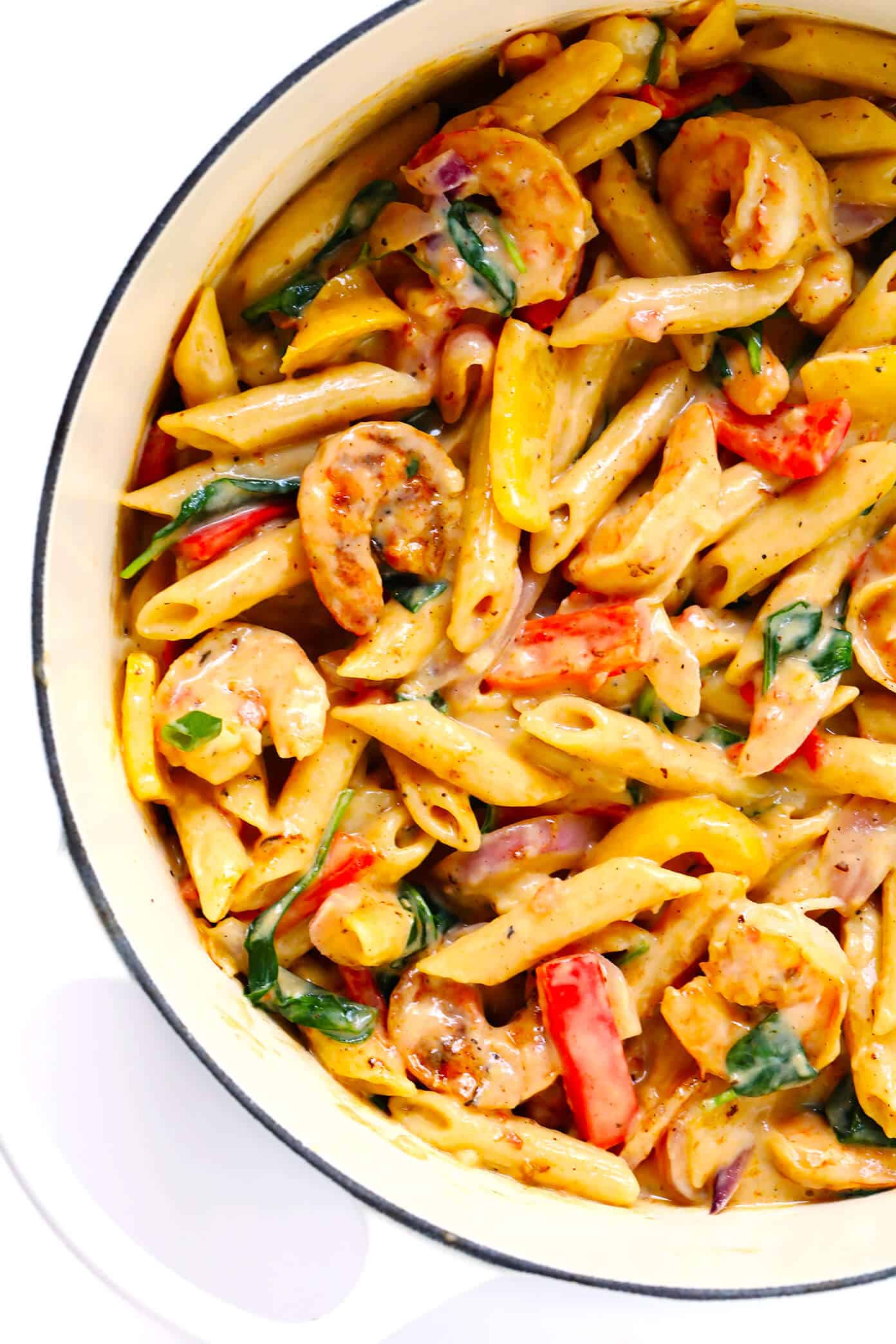 This Cajun Shrimp Pasta recipe is made with the most delicious creamy alfredo sauce, colorful veggies, and zesty shrimp (or chicken, sausage, or your preferred protein). It's comfort food with a kick! | gimmesomeoven.com #pasta #cajun #shrimp #dinner #recipe #alfredo #sauce Creamy Cajun Shrimp Pasta Recipe