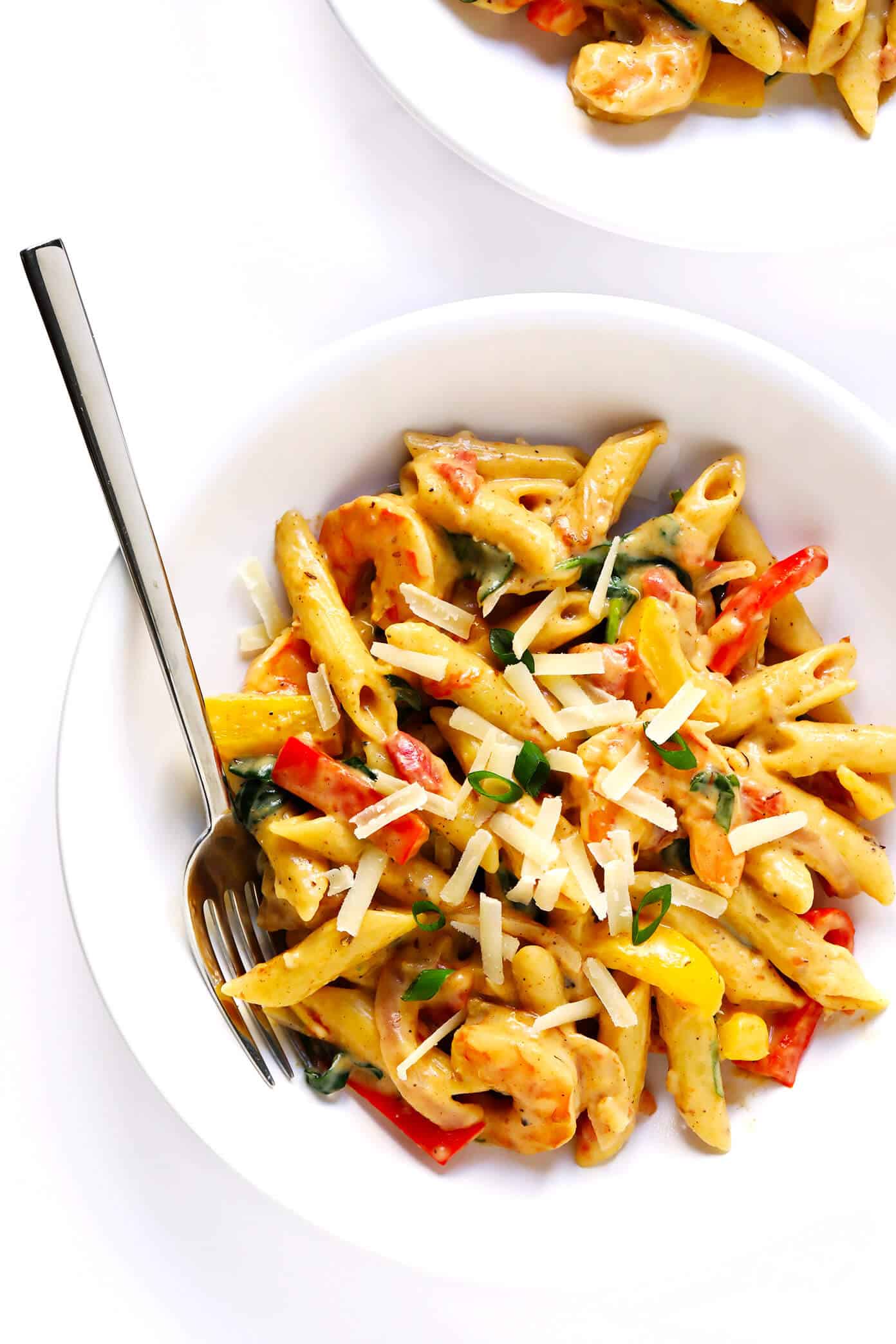 This Cajun Shrimp Pasta recipe is made with the most delicious creamy alfredo sauce, colorful veggies, and zesty shrimp (or chicken, sausage, or your preferred protein). It's comfort food with a kick! | gimmesomeoven.com #pasta #cajun #shrimp #dinner #recipe #alfredo #sauce Creamy Cajun Pasta with Shrimp and Vegetables