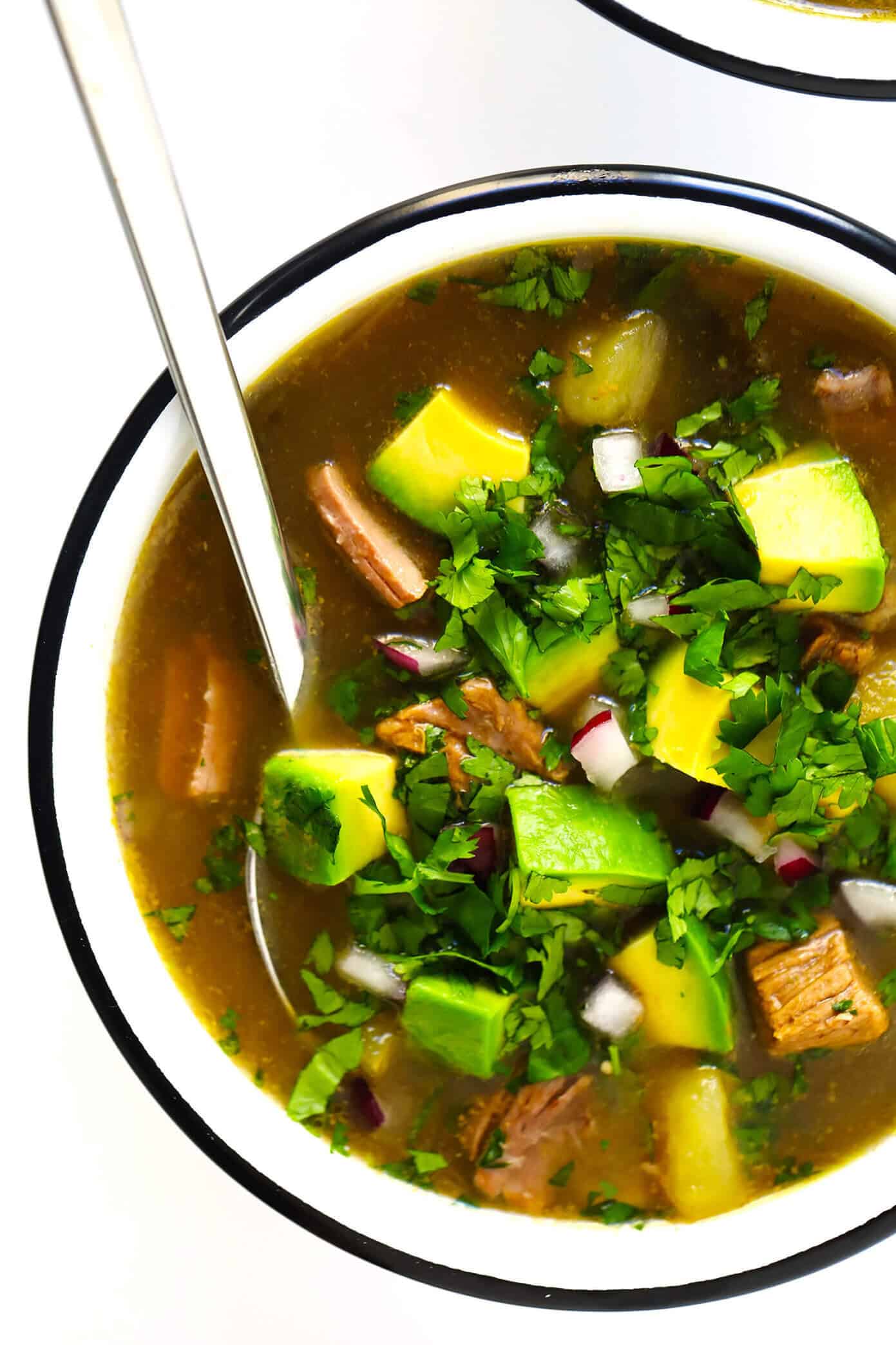 LOVE this Salsa Verde Steak Soup recipe!! It's easy to make in the Instant Pot, Crock-Pot or on the stovetop. It's full of tender beef, potatoes, poblano, and loaded up with lots of favorite toppings. And it is so cozy and delicious. | Gimme Some Oven #soup #mexican #beef #avocado #glutenfree #stew #instantpot #pressurecooker #slowcooker #crockpot #dinner Salsa Verde Steak Soup with Avocado and Cilantro
