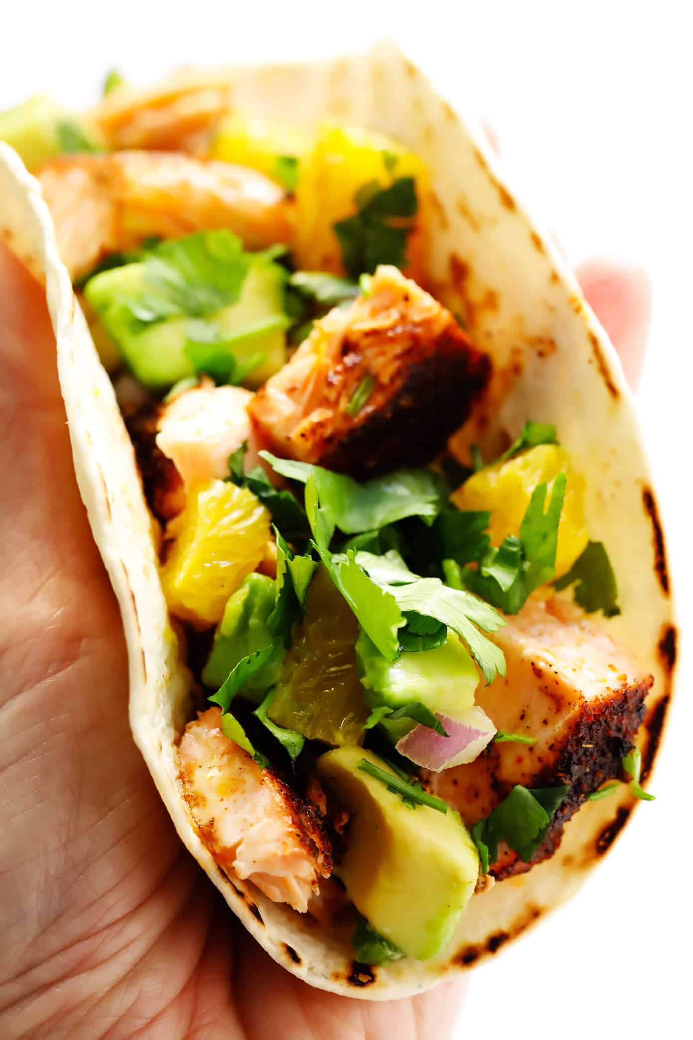 These Super-Simple Salmon Tacos are topped with a juicy fresh orange avocado salsa, seasoned with a zesty chili rub, and can be on the table in just 30 minutes. A delicious, quick, easy and healthy dinner recipe that everyone will love! | gimmesomeoven.com #salmon #tacos #mexican #fish #glutenfree #salsa #dinner #healthy The Best Salmon Tacos
