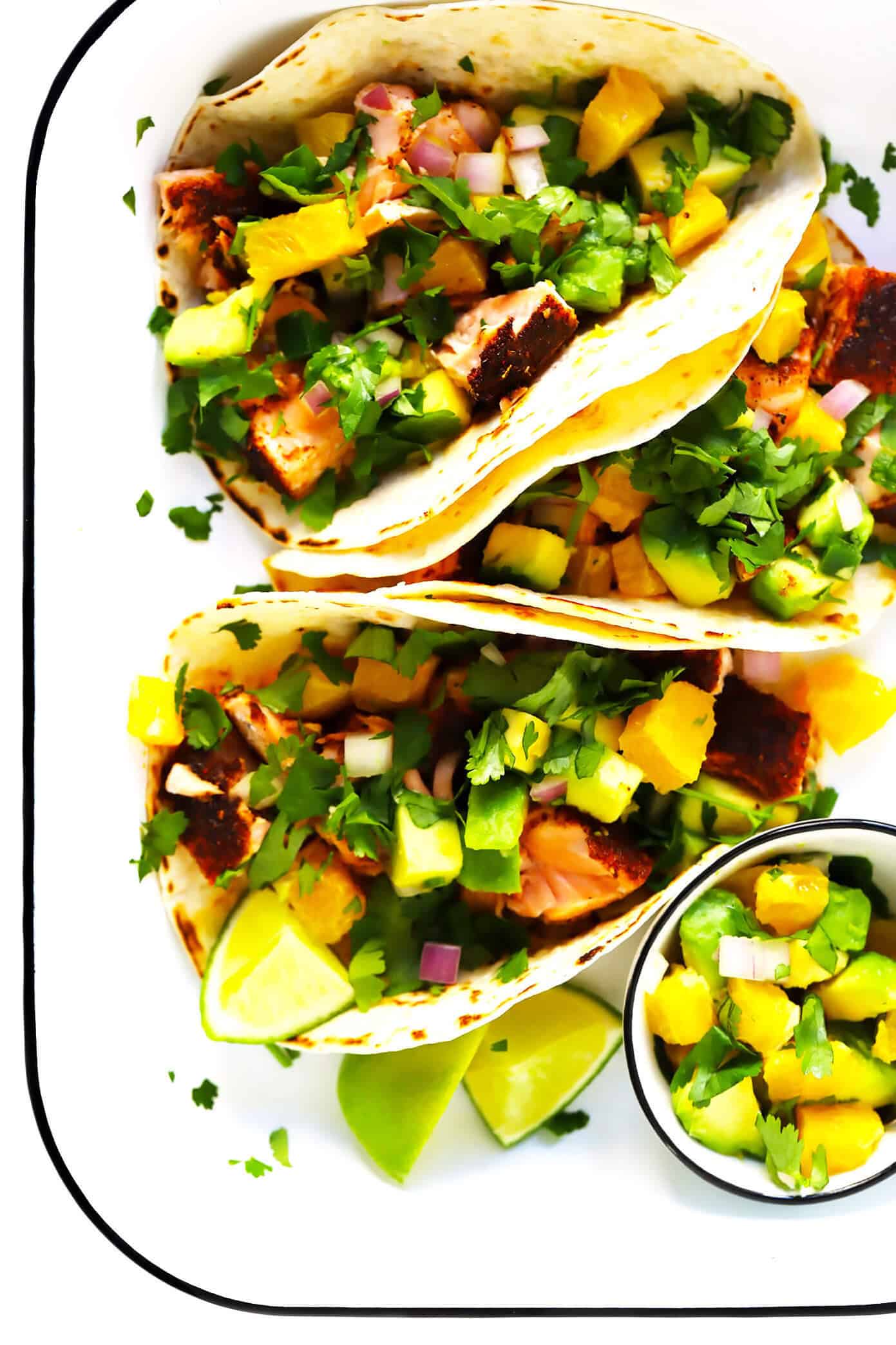 These Super-Simple Salmon Tacos are topped with a juicy fresh orange avocado salsa, seasoned with a zesty chili rub, and can be on the table in just 30 minutes. A delicious, quick, easy and healthy dinner recipe that everyone will love! | gimmesomeoven.com #salmon #tacos #mexican #fish #glutenfree #salsa #dinner #healthy Super-Simple Salmon Tacos with Juicy Orange Avocado Salsa