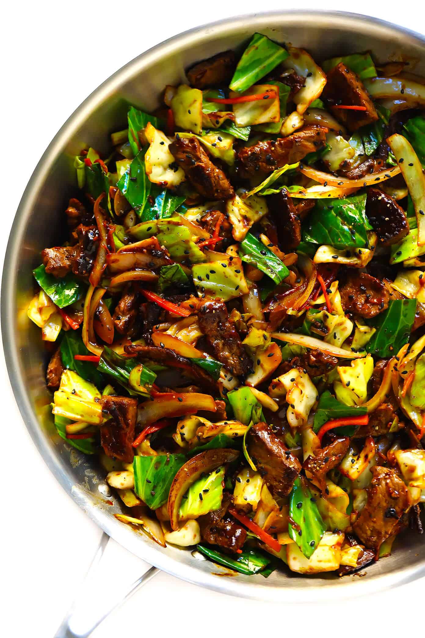 This Sesame Beef and Cabbage Stir-Fry recipe is loaded up with lots of tender steak and veggies, tossed in a yummy sesame ginger sauce, and perfect for easy weeknight dinners or healthy meal prep! Serve over rice, noodles, quinoa -- you name it. | gimmesomeoven.com #beef #stirfry #mealprep #dinner #healthy #chinese #rice Sesame Beef and Cabbage Stir-Fry