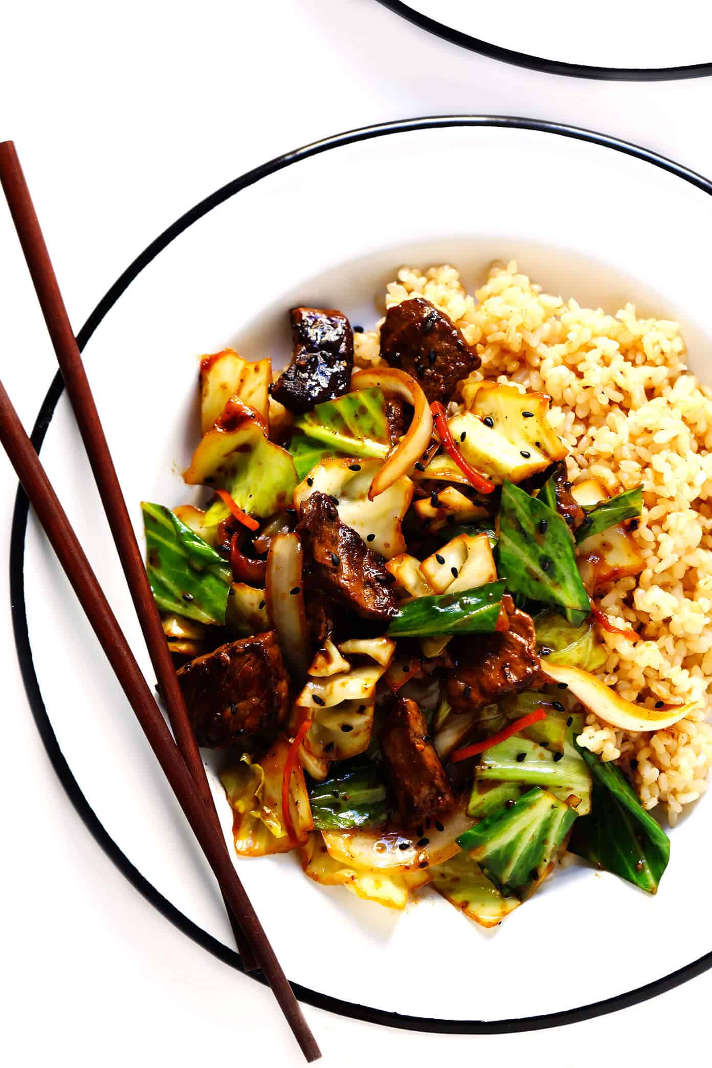 This Sesame Beef and Cabbage Stir-Fry recipe is loaded up with lots of tender steak and veggies, tossed in a yummy sesame ginger sauce, and perfect for easy weeknight dinners or healthy meal prep! Serve over rice, noodles, quinoa -- you name it. | gimmesomeoven.com #beef #stirfry #mealprep #dinner #healthy #chinese #rice Ginger Beef and Cabbage Stir-Fry with Rice