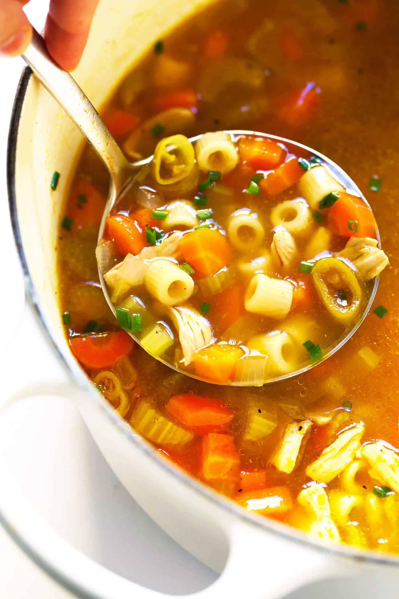 LOVE this Spicy Pepperoncini Chicken Noodle Soup recipe! It's quick and easy to make, and the pepperoncini peppers add the perfect extra bit of heat and tang. Total comfort food! | gimmesomeoven.com #soup #chicken #chickennoodlesoup #pepperoncini #italian #spicy #comfortfood #dinner #recipe Chicken Noodle Soup recipe with Spicy Pepperoncini Peppers
