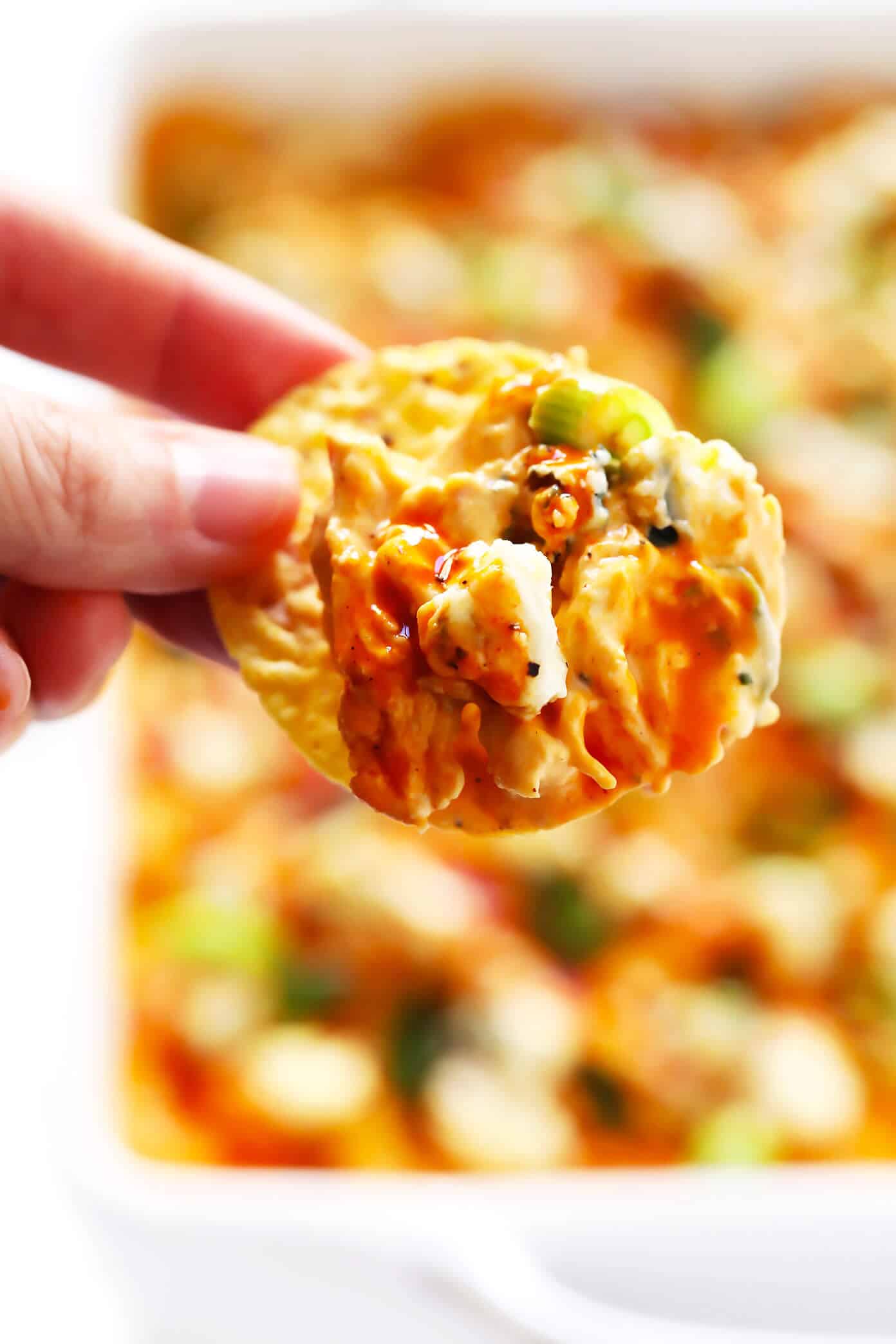 The Best Buffalo Chicken Dip recipe! It's easy to make (in the oven, on the stovetop, or in the slow cooker), full of the best bold flavors, and ALWAYS a crowd fave. | gimmesomeoven.com #dip #appetizer #chicken #superbowl #snack #crockpot Buffalo Chicken Dip with Chips