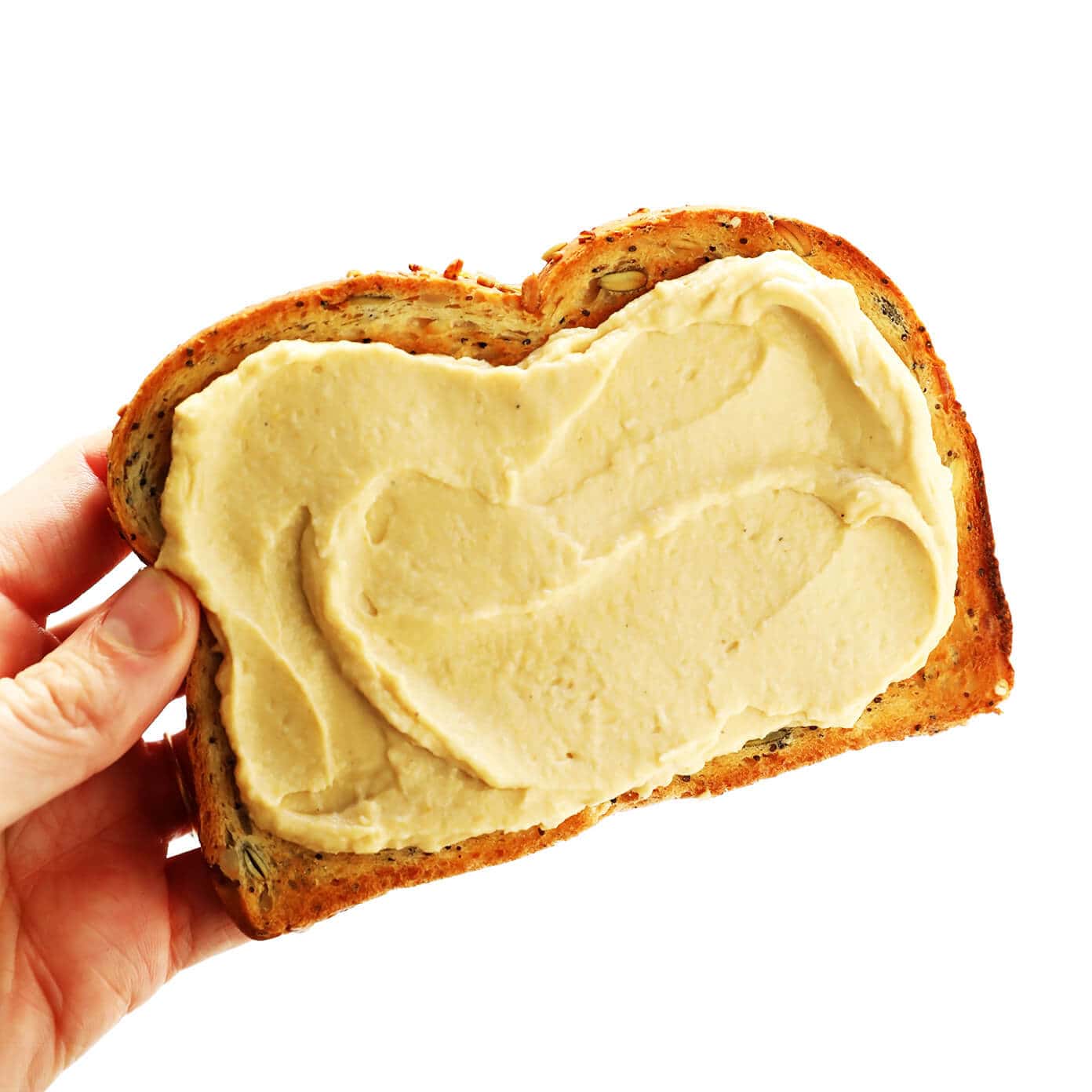 Hummus Toast is fun to customize with your favorite toppings, and makes for a delicious easy breakfast, lunch, dinner or healthy snack! Read more for details on 8 of our favorite toppings -- "everything", avocado, elote, tomato basil, lox, fried egg, mediterranean or honey banana. | gimmesomeoven.com #hummus #toast #healthy #breakfast #dinner #lunch #snack Hummus Toast Recipe