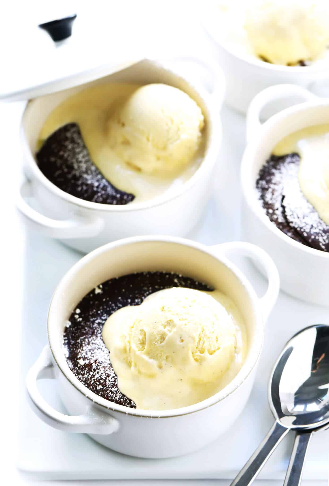 This Dreamy Chocolate Lava Cakes recipe is the BEST! They're quick and easy to make in 20 minutes with just 7 ingredients. And that moist cake with its gooey, molten center is just as rich and decadent and chocolatey as ever. | gimmesomeoven.com #dessert #chocolate #cake #easy #pudding #party #valentines Molten Chocolate Lava Cakes with Ice Cream