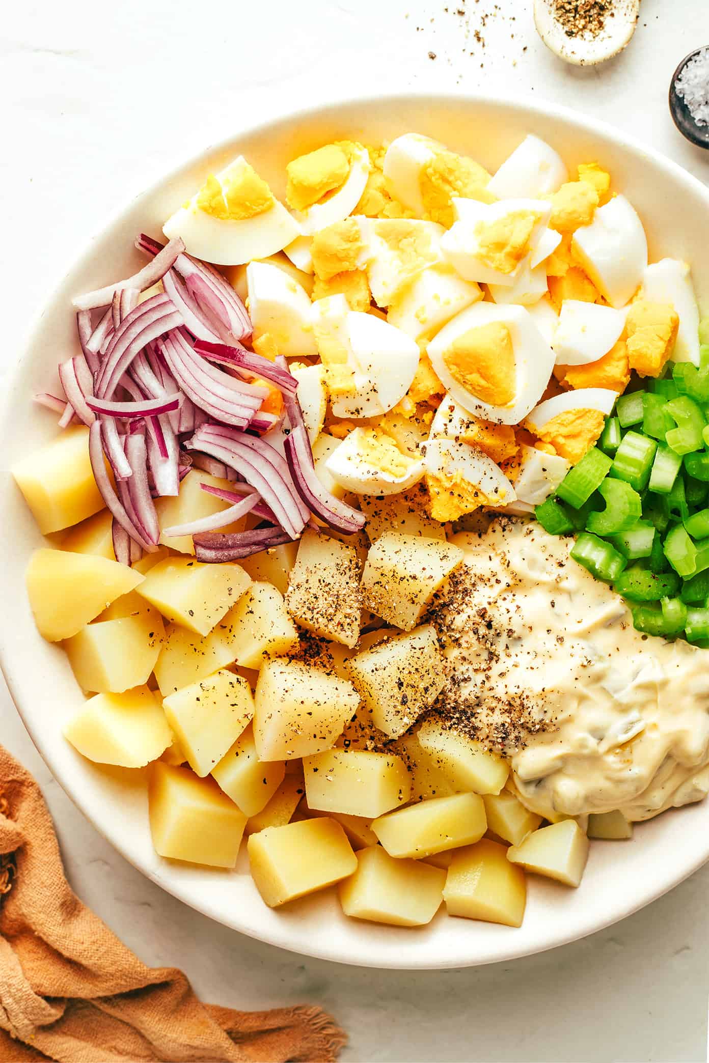 My go-to classic potato salad recipe is easy to make with tender potatoes, hard-boiled eggs, crisp veggies, pickle relish, and a zesty creamy dressing. It's the perfect make ahead side dish for potlucks, picnics and barbecues. And feel free to add some extra bacon or cheese if you'd like! | gimmesomeoven.com Potato Salad Ingredients In A Bowl