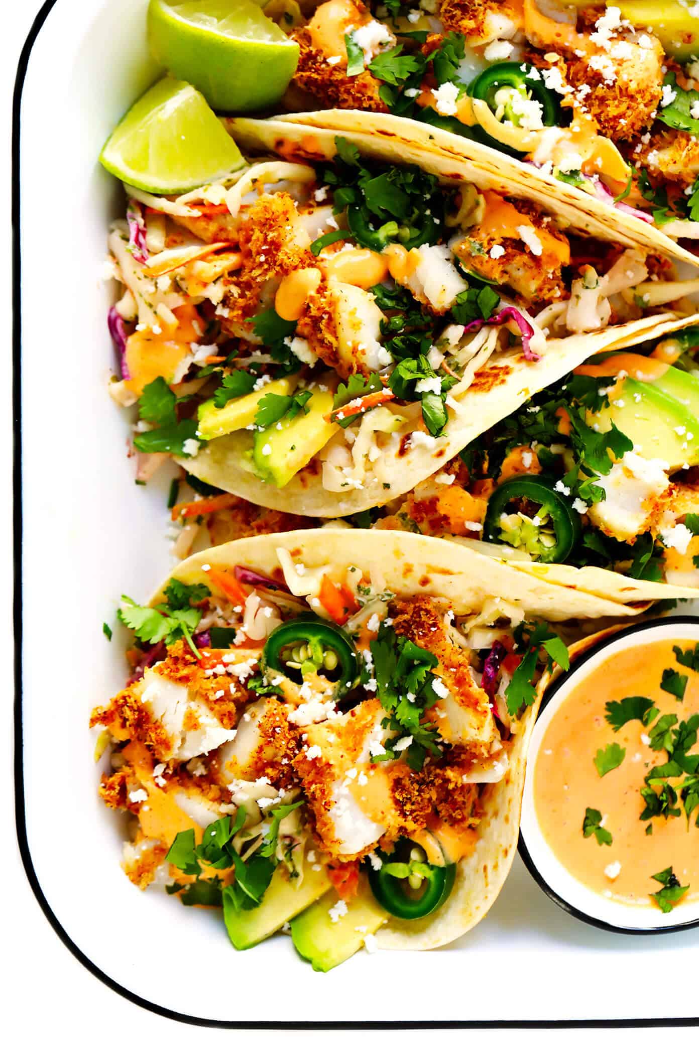 The BEST fish taco recipe!! These fish tacos are made with crispy baked Panko-crusted fish, cilantro lime slaw, chipotle crema, avocado, and whatever other toppings you love most! They're also easy to make gluten-free and dairy-free if you would like, and SO DELICIOUS. | gimmesomeoven.com #fish #tacos #healthy #mexican #dinner #glutenfree Crispy Baked Fish Tacos