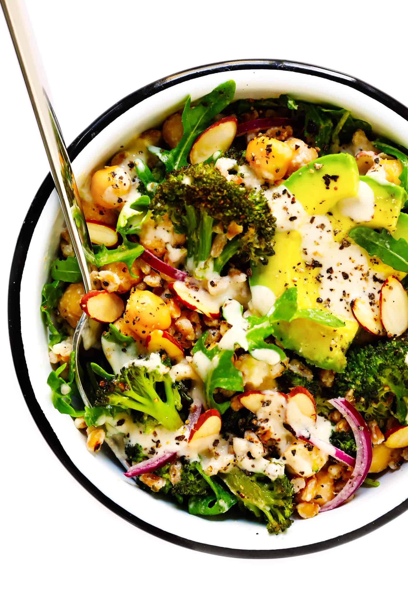 These Roasted Broccoli and Farro Bowls are easy to make with avocado, chickpeas, arugula, red onion, toasted almonds, and the dreamiest tahini dressing. Naturally #glutenfree, #vegetarian, #vegan...and so delicious! | gimmesomeoven.com #broccoli #farro #dinner #healthy #mealprep #grainbowl Roasted Broccoli and Farro Bowls Recipe
