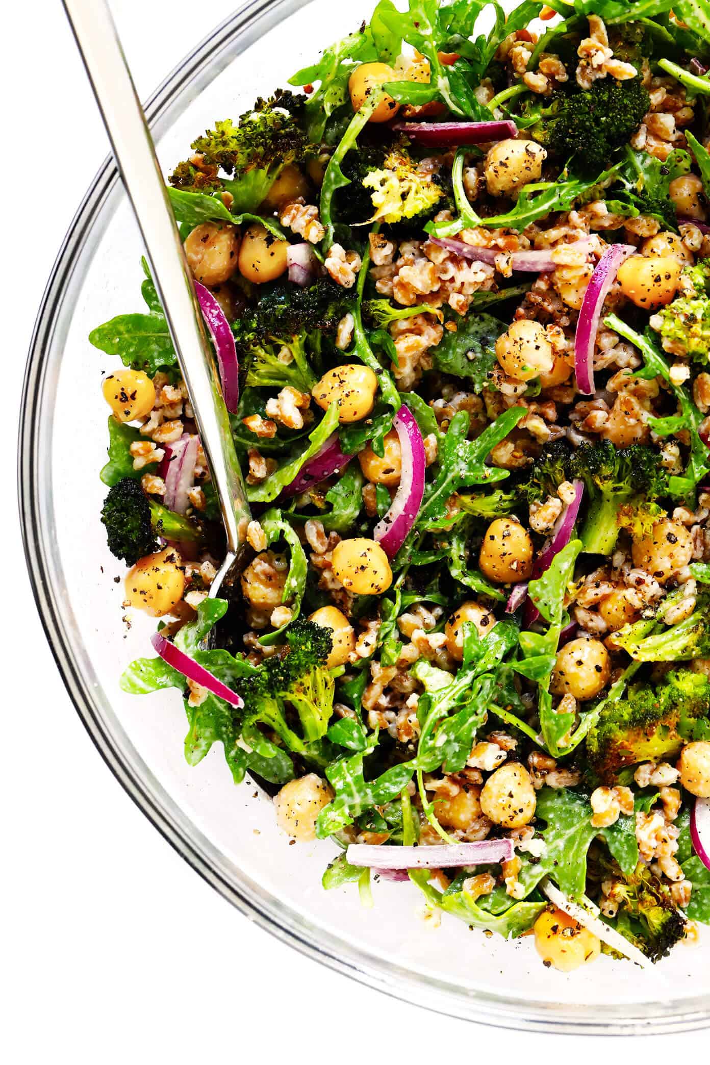 These Roasted Broccoli and Farro Bowls are easy to make with avocado, chickpeas, arugula, red onion, toasted almonds, and the dreamiest tahini dressing. Naturally #glutenfree, #vegetarian, #vegan...and so delicious! | gimmesomeoven.com #broccoli #farro #dinner #healthy #mealprep #grainbowl Roasted Broccoli and Farro Salad with Chickpeas