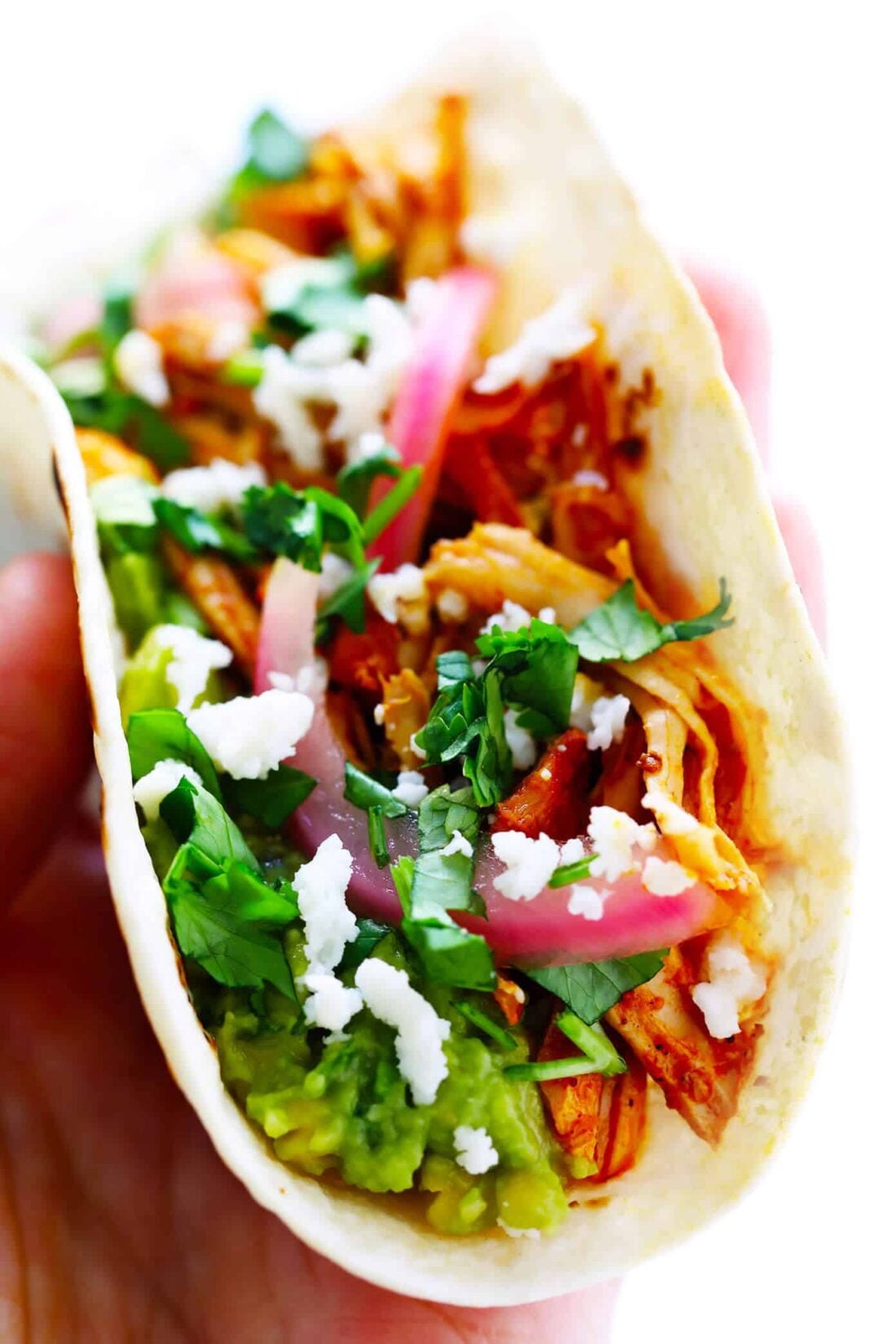 This 5-ingredient cochinita pibil recipe is easy to make in the Instant Pot (pressure cooker) or Crock Pot (slow cooker), it's full of the BEST savory citrus flavors, and this Mexican pulled pork can be served in everything from tacos to burritos, nachos and more. | gimmesomeoven.com #mexican #pork #instantpot #crockpot #tacos #dinner #mealprep Cochinita Pibil Tacos Recipe