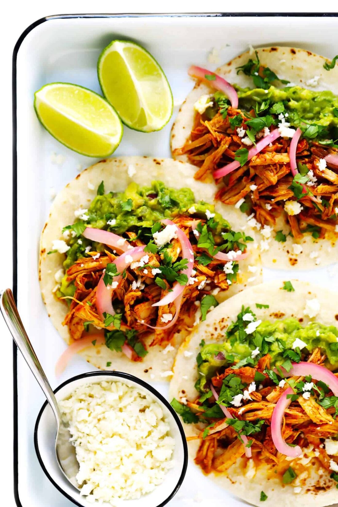 This 5-ingredient cochinita pibil recipe is easy to make in the Instant Pot (pressure cooker) or Crock Pot (slow cooker), it's full of the BEST savory citrus flavors, and this Mexican pulled pork can be served in everything from tacos to burritos, nachos and more. | gimmesomeoven.com #mexican #pork #instantpot #crockpot #tacos #dinner #mealprep Cochinita Pibil Tacos Recipe with Pickled Red Onions