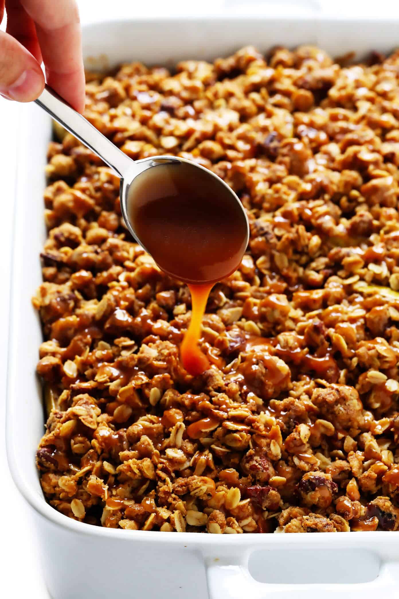 This easy apple crisp recipe (a.k.a. apple crumble) is made with a warm cinnamon apple filling and an irresistible buttery crunchy streusel topping. Plus this no-fuss version takes less than 20 minutes to prep -- the perfect fall dessert recipe! | gimmesomeoven.com #apple #crisp #crumble #dessert #fall #winter #thanksgiving #glutenfree #vegan Easy Apple Crisp Recipe with Caramel Sauce