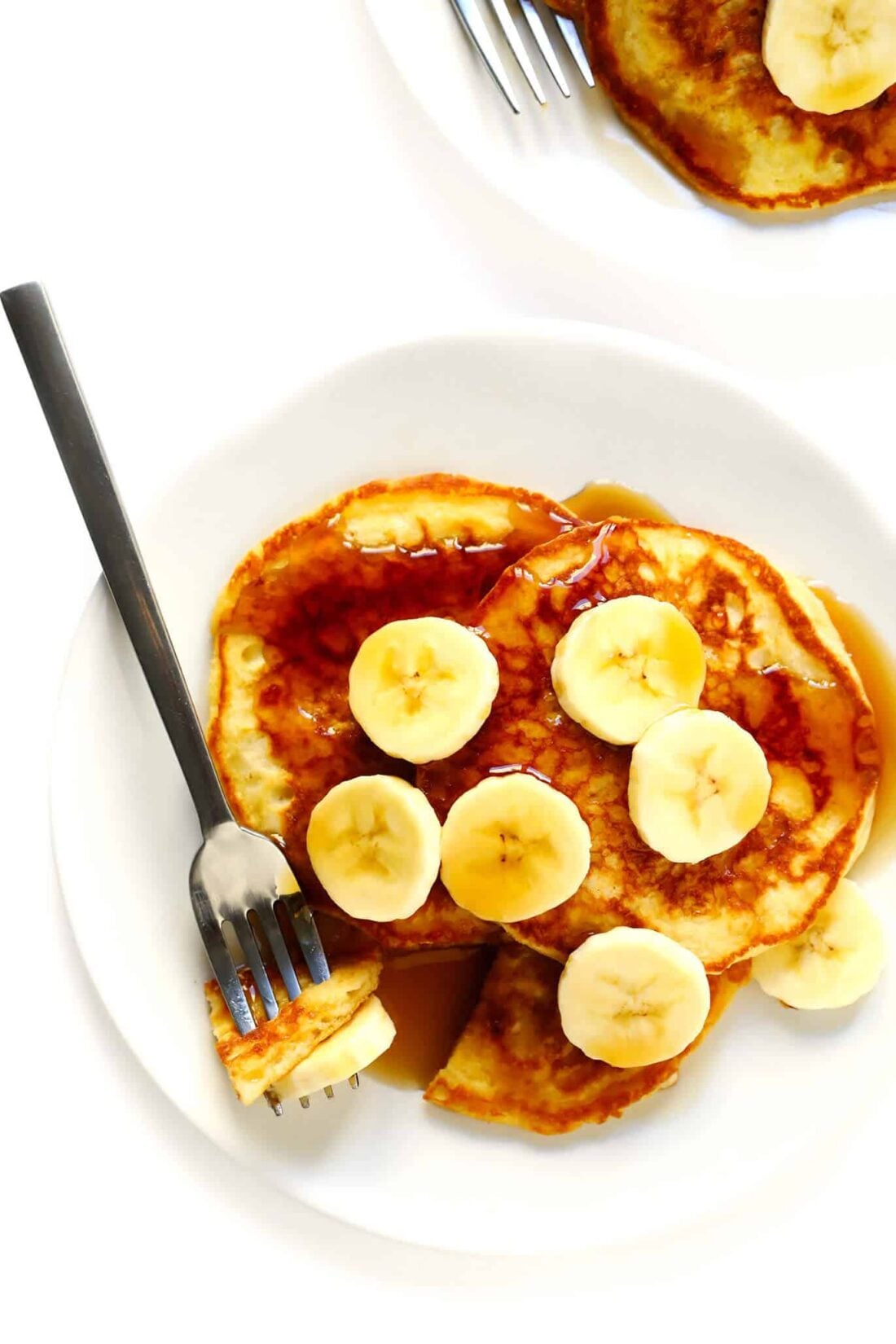 The BEST buttermilk pancakes recipe -- easy to make, full of those comforting flavors we all love, and the perfect blank canvas for all of your favorite add-ins (banana, blueberry, chocolate chip, nuts, you choose!). A simple breakfast recipe that's always a winner. | gimmesomeoven.com #pancakes #breakfast #brunch #recipe #mealprep Buttermilk Pancakes Recipe with Bananas