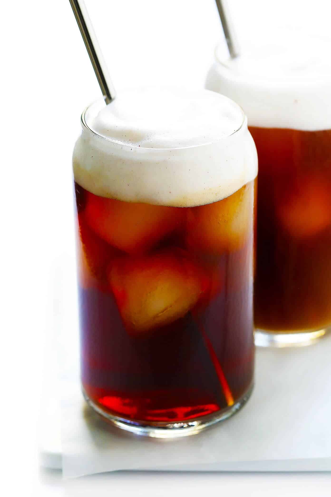 This DIY Pumpkin Cream Cold Brew recipe is inspired by the new Starbucks drink and topped with the yummiest pumpkin foam! Feel free to use your favorite kind of iced coffee, plus whichever type of milk and sweetener you prefer. | gimmesomeoven.com #pumpkin #coldbrew #coffee #breakfast #healthy #drink Pumpkin Spice Cold Brew Iced Coffee