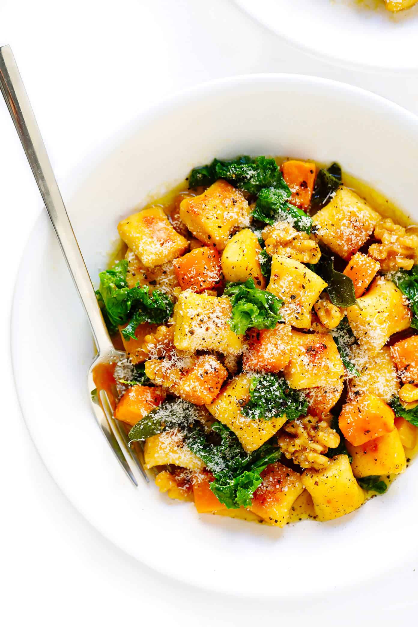 Toasted gnocchi, roasted butternut squash, garlicky kale and walnuts are all tossed together in the yummiest sage brown butter sauce and Parmesan cheese. It's total fall comfort food...and surprisingly easy to make too! | gimmesomeoven.com #gnocchi #italian #dinner #butternutsquash #fall #healthy #vegetarian Autumn Gnocchi with Kale, Butternut Squash, and Brown Butter Sauce