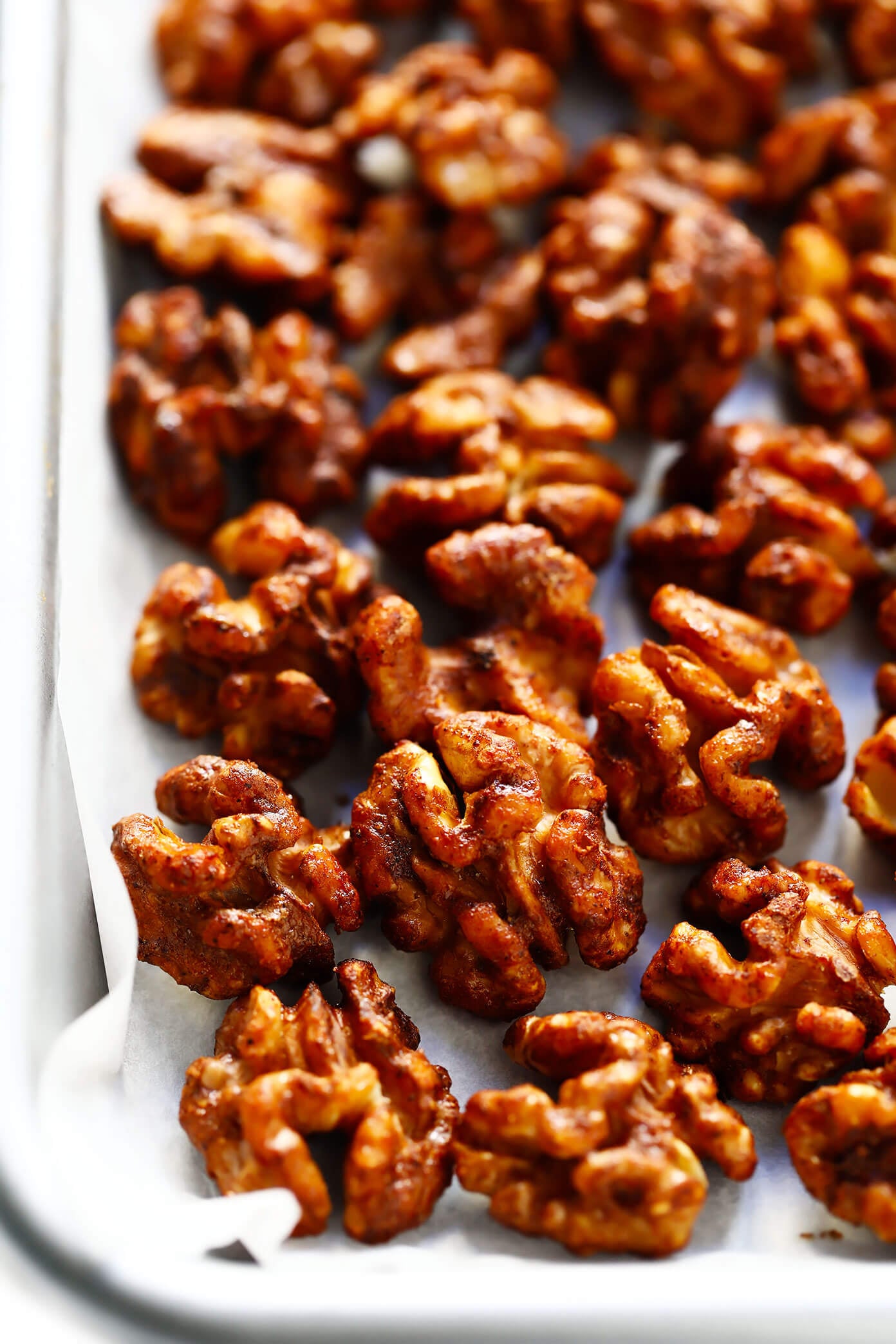 The BEST candied walnuts recipe -- lightly sweetened with a brown sugar cinnamon coating, easy to make in the oven, and irresistibly delicious. These candied nuts are perfect for adding to salads, sweet potatoes, trail mix, or popping plain as a snack! | gimmesomeoven.com #candied #walnuts #nuts #dessert #holiday #gift #diy Candied Walnuts Recipe