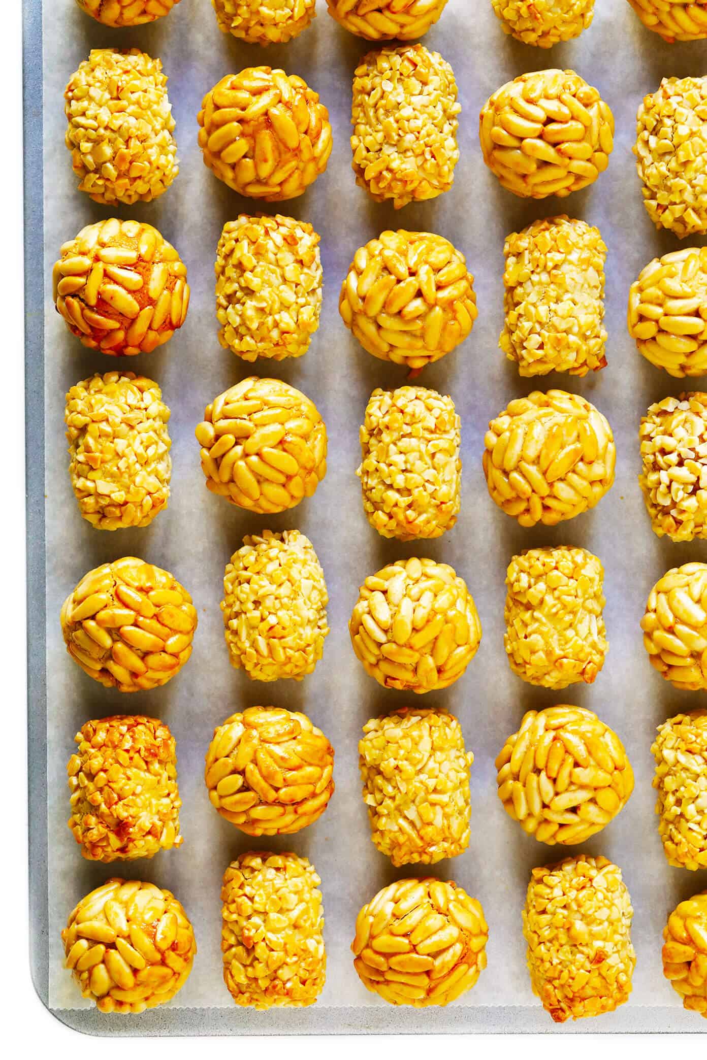 This traditional Catalan panellets recipe is easy to make with just 6 ingredients and fun to customize with different toppings (such as pine nuts, almonds, coconut, cocoa and more). | gimmesomeoven.com #panellets #dessert #catalonia #spain #marzipan Panellets with Pine Nuts and Almonds