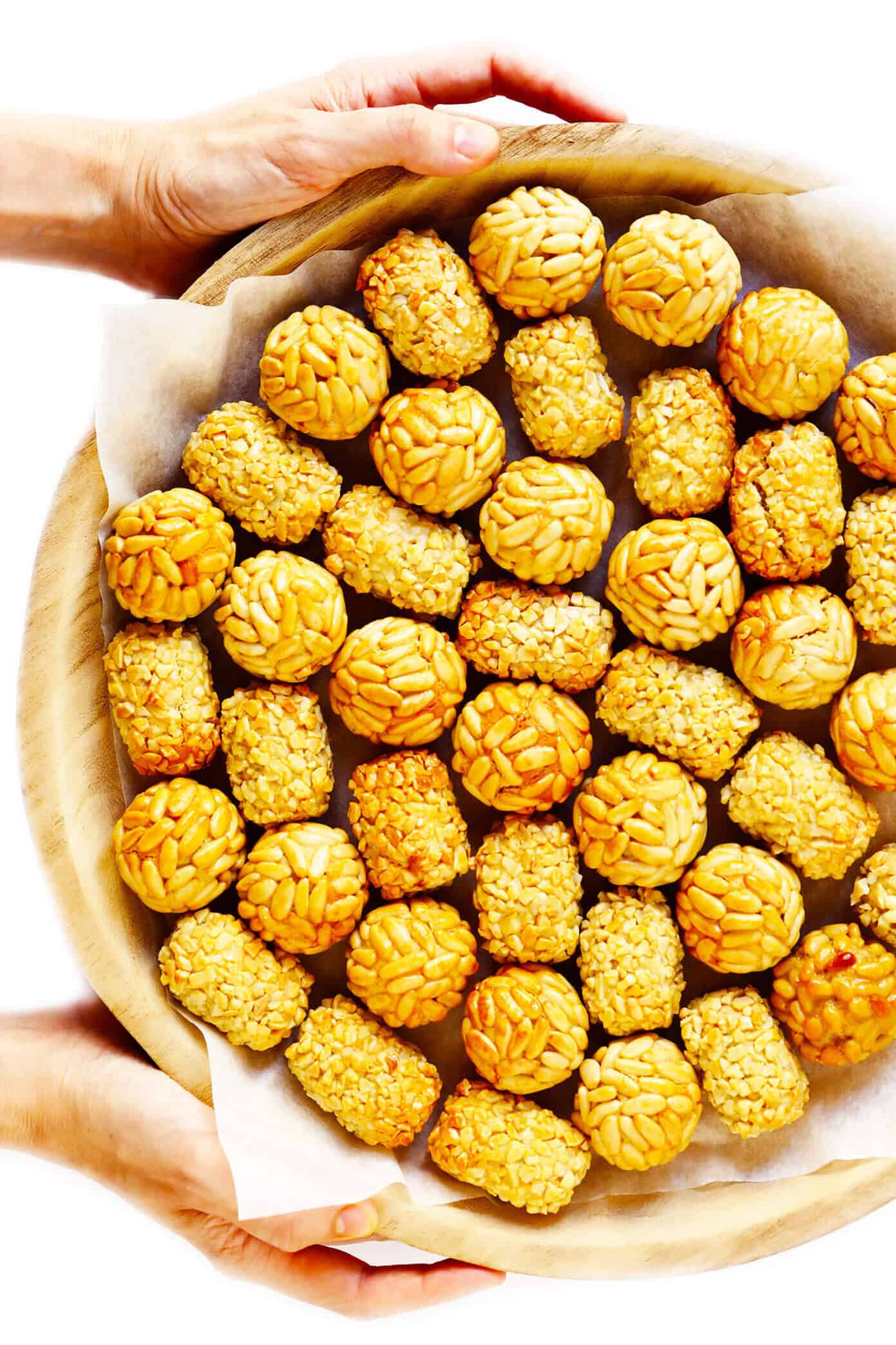 This traditional Catalan panellets recipe is easy to make with just 6 ingredients and fun to customize with different toppings (such as pine nuts, almonds, coconut, cocoa and more). | gimmesomeoven.com #panellets #dessert #catalonia #spain #marzipan Panellets
