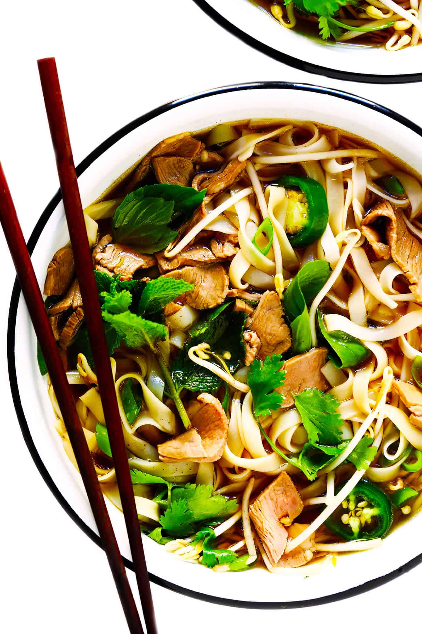 This homemade Vietnamese pho recipe is made with a rich and savory broth, rice noodles, beef (or chicken, pork or shrimp), and then loaded up with lots of fresh herbs and toppings. Always a delicious dinner idea when you're craving a big bowl of soup, and it's naturally gluten-free too! | gimmesomeoven.com Vietnamese Pho Soup