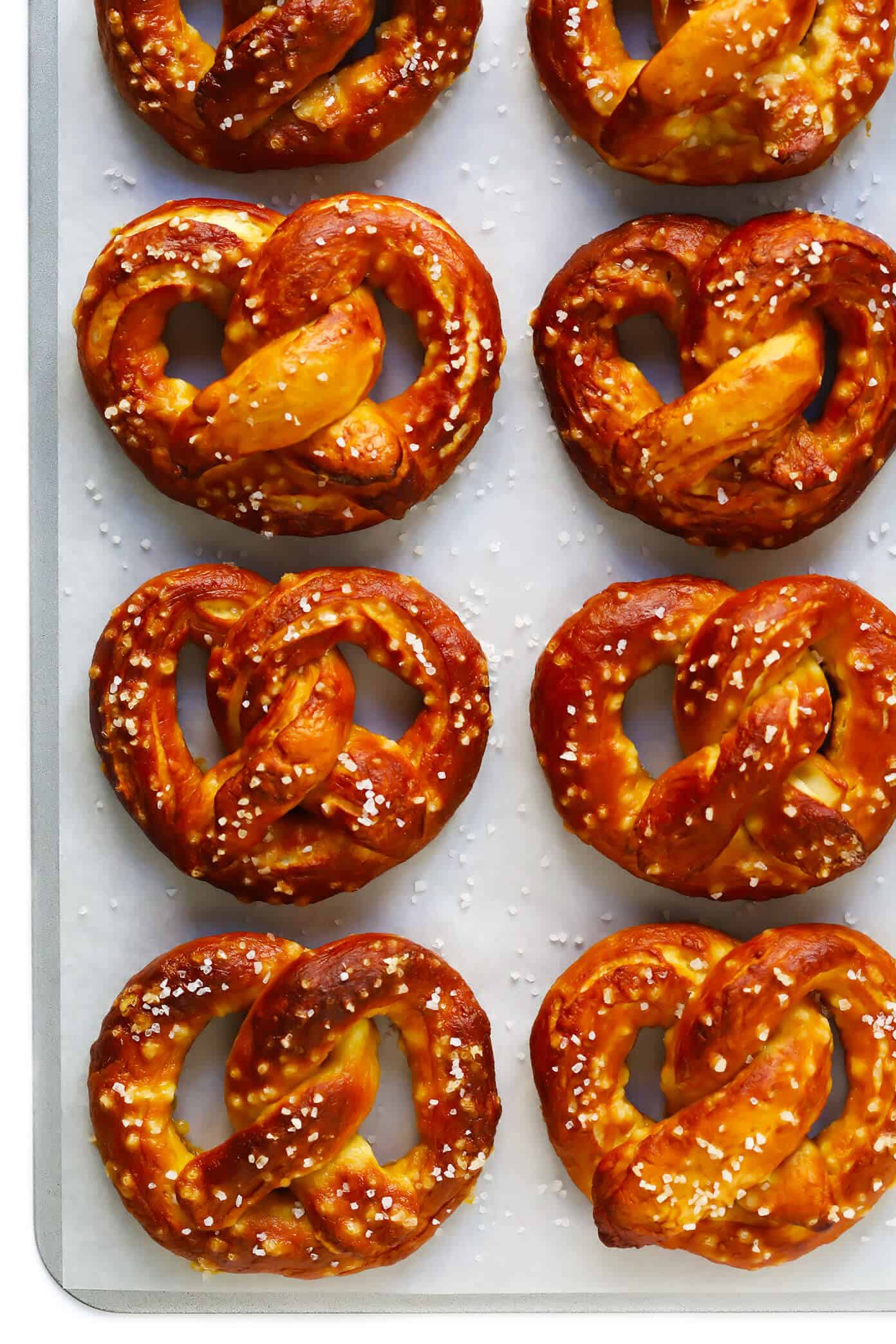The BEST hot and buttery homemade soft pretzels! Easy to make in just 1 hour, and customizable with any of your favorite toppings. | gimmesomeoven.com #pretzels #snack #gameday #appetizer #bread #vegetarian #vegan #homemade Buttery Soft Pretzels
