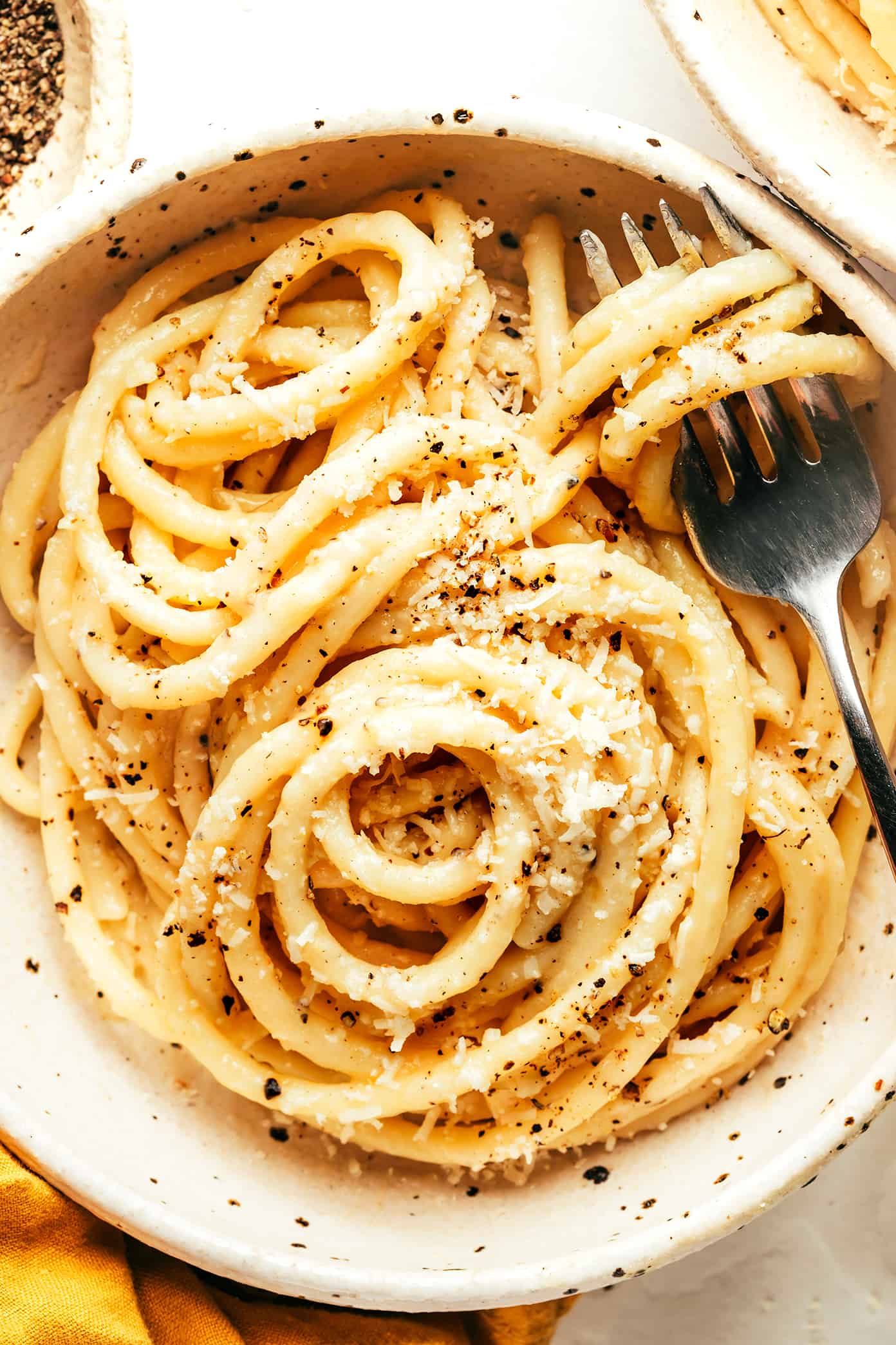 My favorite cacio e pepe recipe is easy to make in about 30 minutes with just 4 simple ingredients -- pasta, cheese (Pecorino, or a blend with Parmesan), guanciale and a hint of butter. Such an easy dinner and always the best Italian comfort food! | gimmesomeoven.com The Best Cacio e Pepe Closeup in Bowl