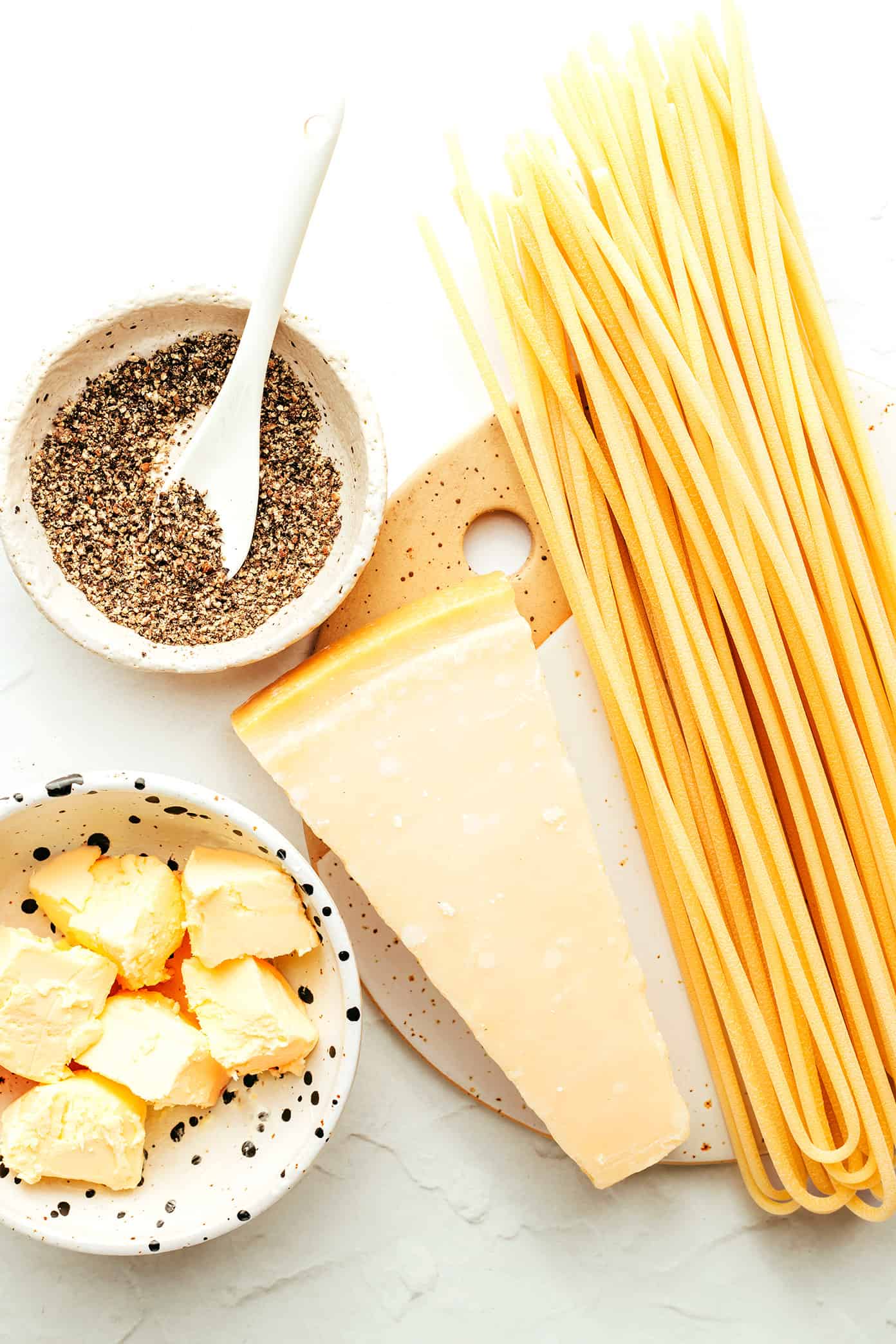 My favorite cacio e pepe recipe is easy to make in about 30 minutes with just 4 simple ingredients -- pasta, cheese (Pecorino, or a blend with Parmesan), guanciale and a hint of butter. Such an easy dinner and always the best Italian comfort food! | gimmesomeoven.com Cacio e Pepe Ingredients